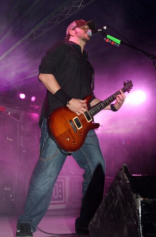 Lead guitarist Troy McLawhorn rocks out during a performance held at the parade deck here May 26. The grunge band Seether went on a weeklong United Service Organizations tour to show their appreciation for the armed services.