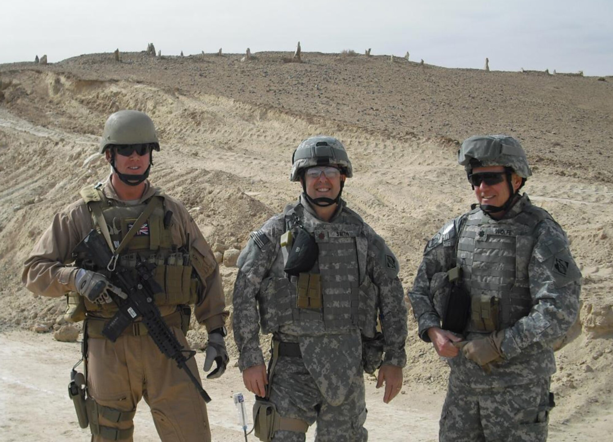AL-ANBAR PROVINCE, Iraq --  Naval Reserve Cmdr. Duane Wolfe, far right, was performing his reserve duties in the Navy when he was killed by injuries received during an improvised explosive device attack. Commander Wolfe served as the civilian deputy commander of the 30th Mission Support Group here. During his deployment, he was assigned as officer in charge of the U.S. Army Corps of Engineers Al Anbar Area Office, Al Asad Air Base, Iraq, (Courtesy photo)
