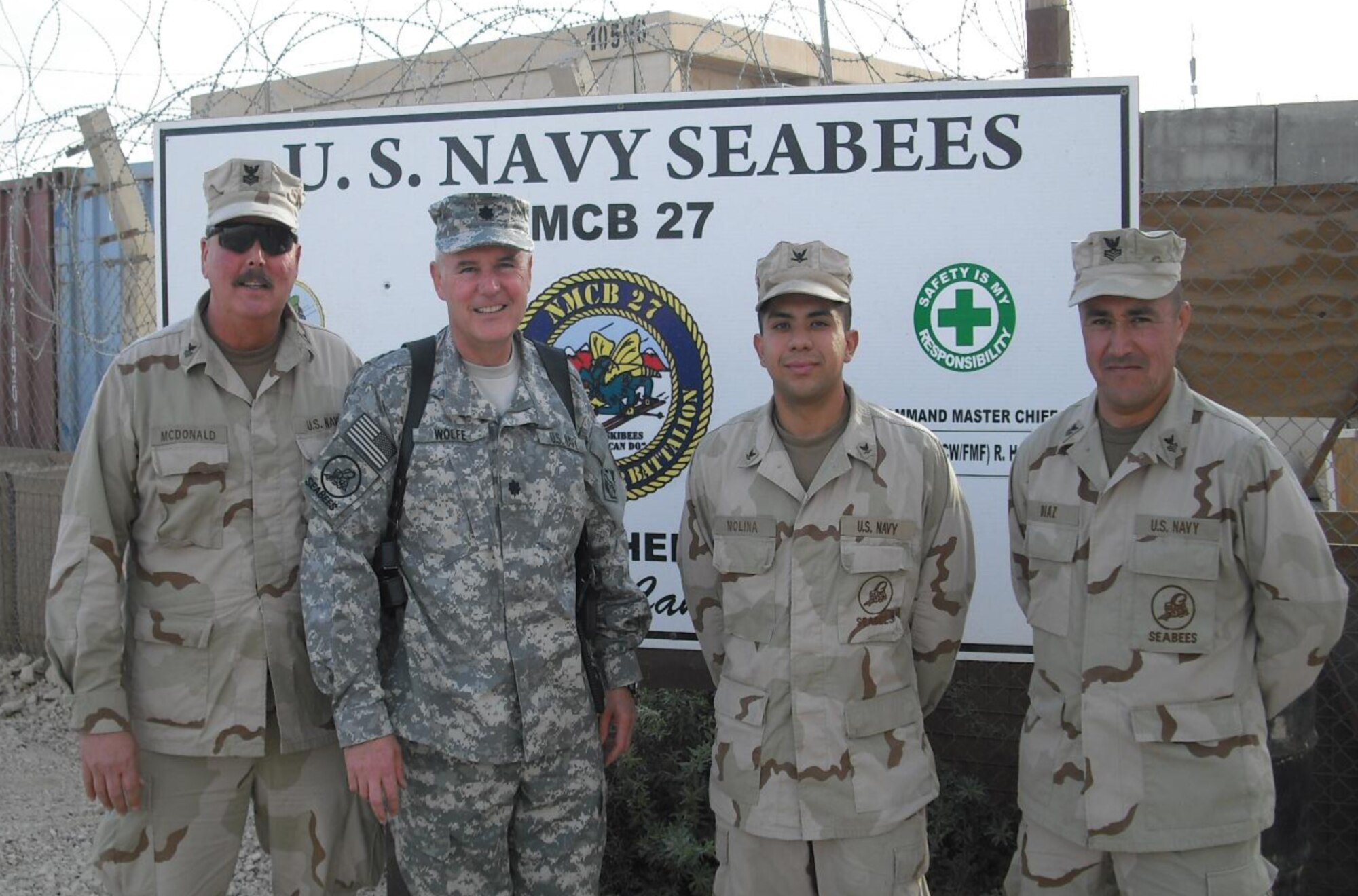 AL-ANBAR PROVINCE, Iraq --  Naval Reserve Cmdr. Duane Wolfe, second from left, was performing his reserve duties in the Navy when he was killed by injuries received during an improvised explosive device attack. Commander Wolfe served as the civilian deputy commander of the 30th Mission Support Group here. During his deployment, he was assigned as officer in charge of the U.S. Army Corps of Engineers Al Anbar Area Office, Al Asad Air Base, Iraq, (Courtesy photo)
