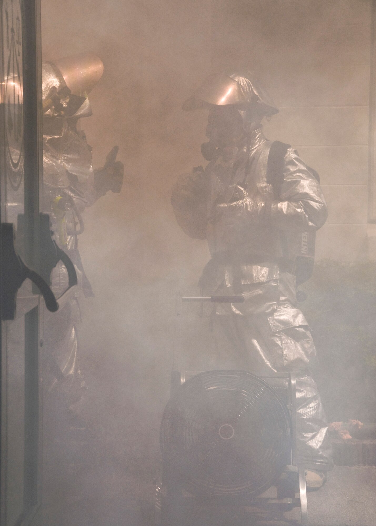 MISAWA AIR BASE, Japan -- Firefighters from the 35th Civil Engineer Squadron ventilate the security forces building as part of an initial readiness response exercise May 19, 2009. The simulated fire was performed to evaluate the fire department's response and the evacuation of the security forces building. (U.S. Air Force photo by Staff Sgt. Araceli Alarcon)
