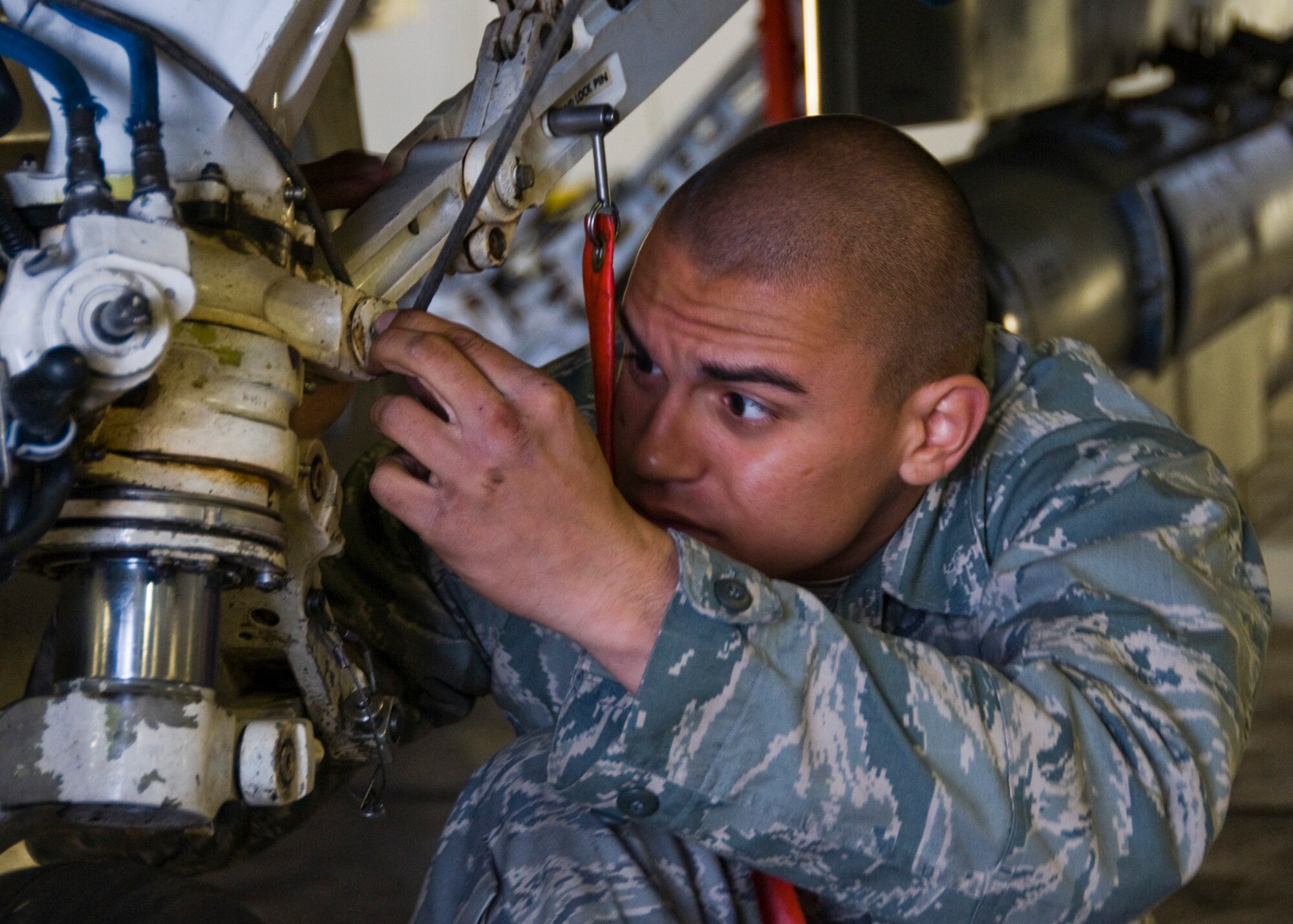 MISAWA AIR BASE, Japan -- Airman Basic Jeremy Perez from the 35th Aircraft Maintenance Squadron inspects the landing gear on an F-16 Fighting Falcon May 18, 2009. The inspection was part of a three-day initial readiness response exercise.  (U.S. Air Force photo by Staff Sgt. Araceli Alarcon)

