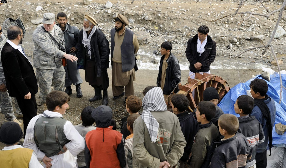 Lt. Col. Mark Stratton talks to villagers about a micro hydro pump provided by the Panjshir Provincial Reconstruction Team in Afghanistan March 4. The micro hydro uses water to create power for the village. Colonel Stratton was killed in action in Afghanistan May 26. Colonel Stratton was the Panjshir PRT commander. (U.S. Air Force photo/Staff Sgt. James L. Harper Jr.)