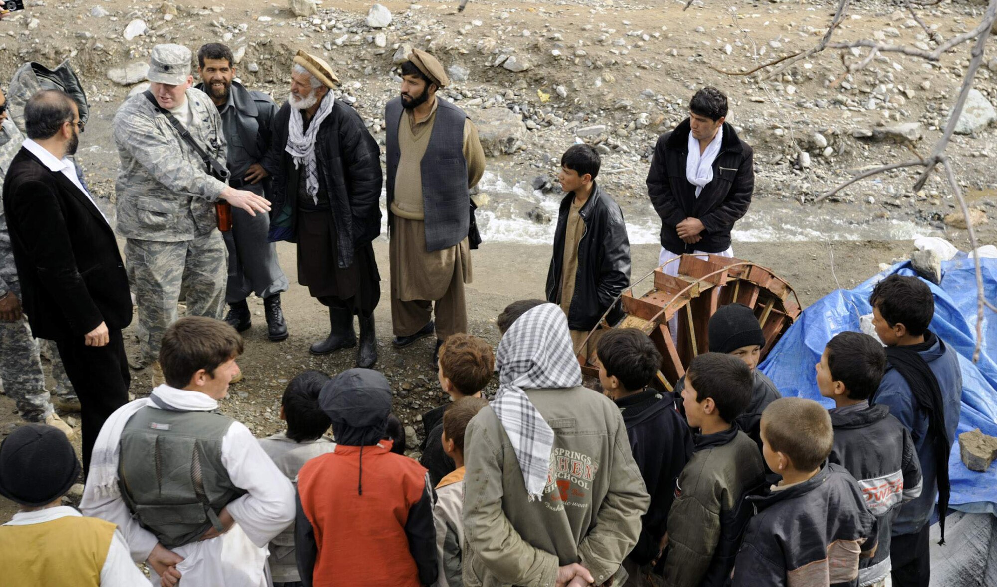 Lt. Col. Mark Stratton talks to villagers about a micro hydro pump provided by the Panjshir Provincial Reconstruction Team in Afghanistan March 4. The micro hydro uses water to create power for the village. Colonel Stratton was killed in action in Afghanistan May 26. Colonel Stratton was the Panjshir PRT commander. (U.S. Air Force photo/Staff Sgt. James L. Harper Jr.)