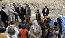 Lt. Col. Mark Stratton talks to villagers about a micro hydro pump provided by the Panjshir Provincial Reconstruction Team in Afghanistan March 4. The micro hydro uses water to create power for the village. Colonel Stratton was killed in action in Afghanistan May 26. Colonel Stratton was the Panjshir PRT commander. (U.S. Air Force photo/Staff Sgt. James L. Harper Jr.)