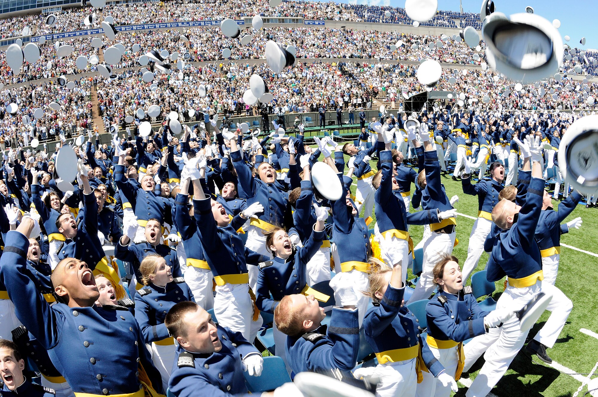 The 1,046 newly commissioned second lieutenants at the U.S. Air Force Academy commemorate their achievement by tossing their hats as the Air Force Thunderbirds fly over Falcon Stadium May 27.  (U.S. Air Force photo/Mike Kaplan)