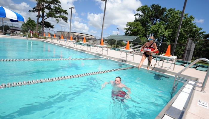 Jenna Pender practices lifeguard skills on Rick Hallett at the base pool May 26. Ms. Pender and Mr. Hallett are civilian lifeguards with the 437th Force Support Squadron. (U.S. Air Force photo/Senior Airman Timothy Taylor)