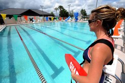Jenna Pender looks for hazards or debris at the base pool may 26. The base pool is now open Tuesdays through Fridays between 6 to 7 a.m. for free lap swimming  and Tuesdays through Sundays between noon and 5 p.m. for recreational swimming. Ms. Pender is a civilian lifeguard with the 437th Force Support Squadron. (U.S. Air Force photo/Senior Airman Timothy Taylor)
