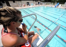 Jenna Pender watches over a swimmer as he swims laps at the base pool May 26. The base pool is now open Tuesdays through Fridays between 6 to 7 a.m. for free lap swimming and Tuesdays through Sundays between noon and 5 p.m. for recreational swimming. Ms. Pender is a civilian lifeguard with the 437th Force Support Squadron. (U.S. Air Force photo/Senior Airman Timothy Taylor)