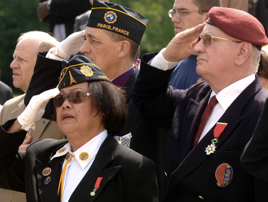 American Legion's Post No. 1 Commander, Clarita Georghegan joins Alain Raye and George La Peyre in honoring the colors during the Lafayette Escadrille Memorial ceremony outside of Paris May 23. (U.S. Air Force photo/Master Sgt. Scott Wagers)  
