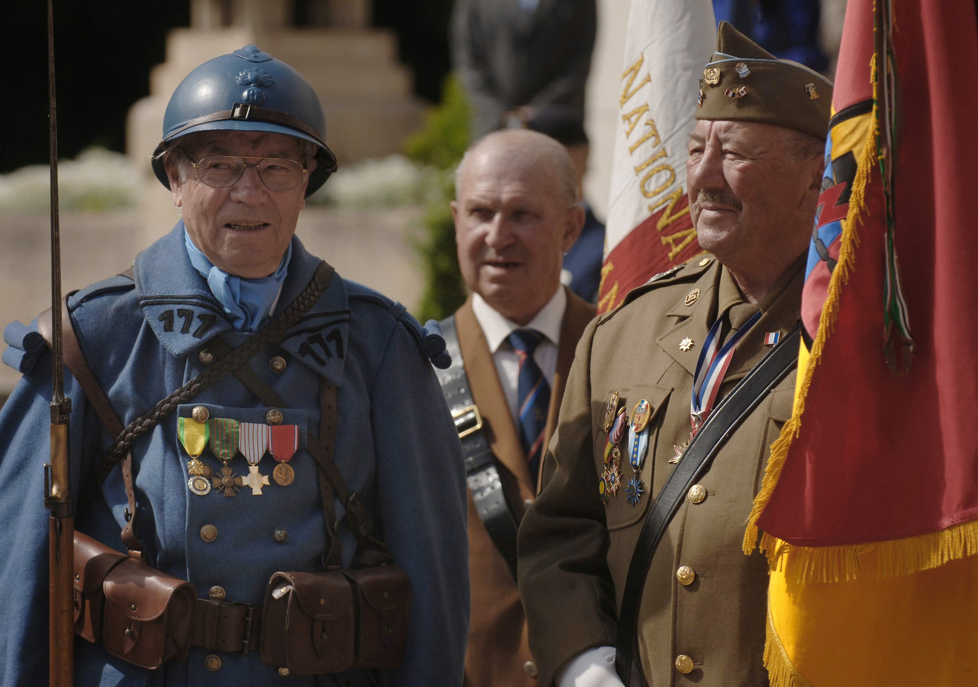French military veterans Roger Prevost and Roger Benier dress in vintage World War I uniforms and wear the colors of the 3rd Army, 7th Armored Division during a memorial ceremony outside of Paris, paying homage to the United States' first combat aviators known as the Lafayette Escadrille. The all-American squadron of volunteers flew under the French flag during World War I. (U.S. Air Force photo/Master Sgt. Scott Wagers)