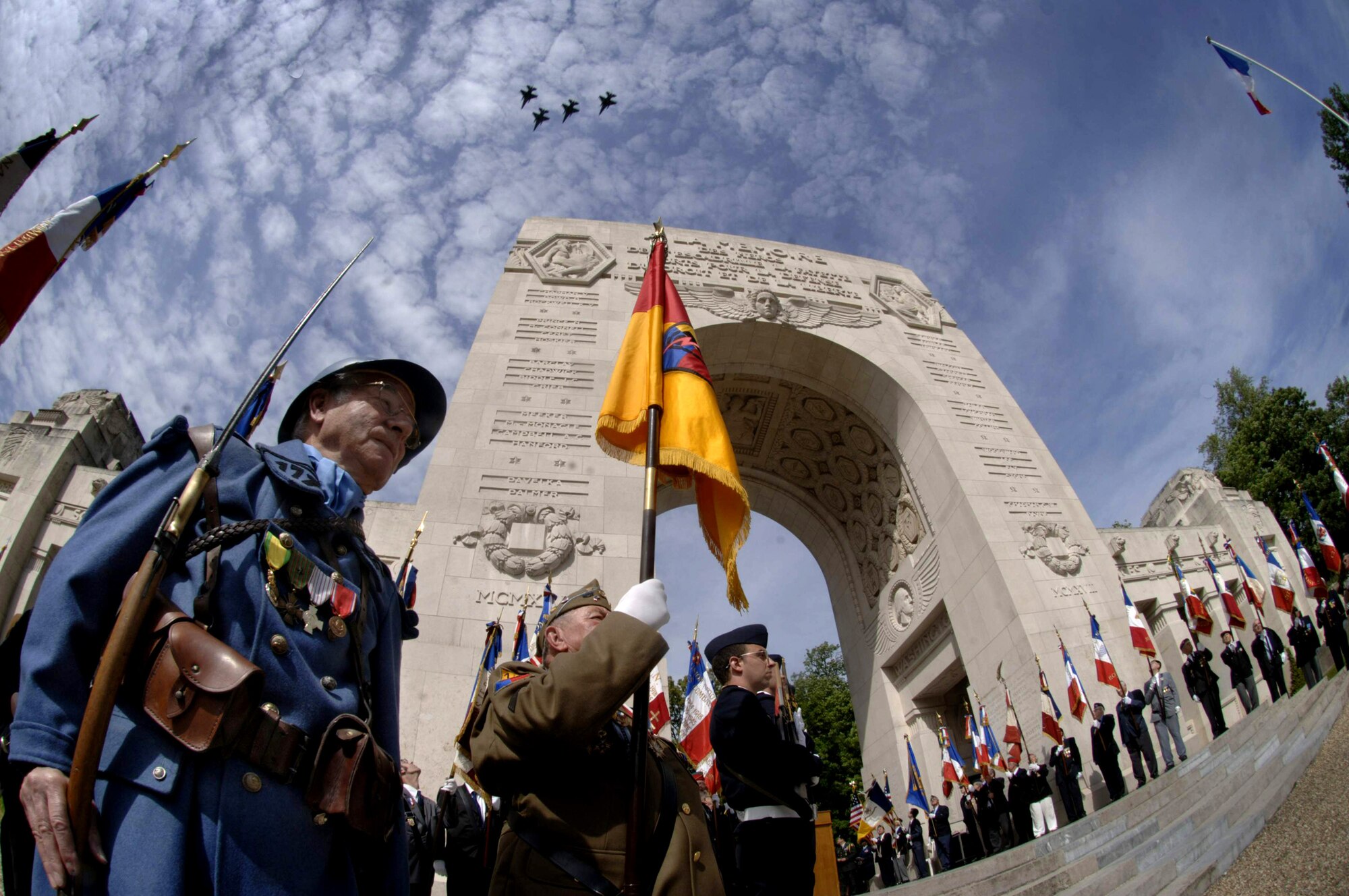 A missing-man formation of F-16 Fighting Falcons follow French Mirages and a Naval Air Factory N3N biplane (not shown) in a flyover at the Lafayette Escadrille Memorial ceremony outside of Paris May 23. French and American citizens here paid homage to some of the United States' first combat aviators known as the Lafayette Escadrille. The all-American squadron of volunteers flew under the French flag during World War I. The F-16s belong to the 52nd Fighter Wing, Spangdahlem Air Base, Germany. (U.S. Air Force photo/Master Sgt. Scott Wagers) 
