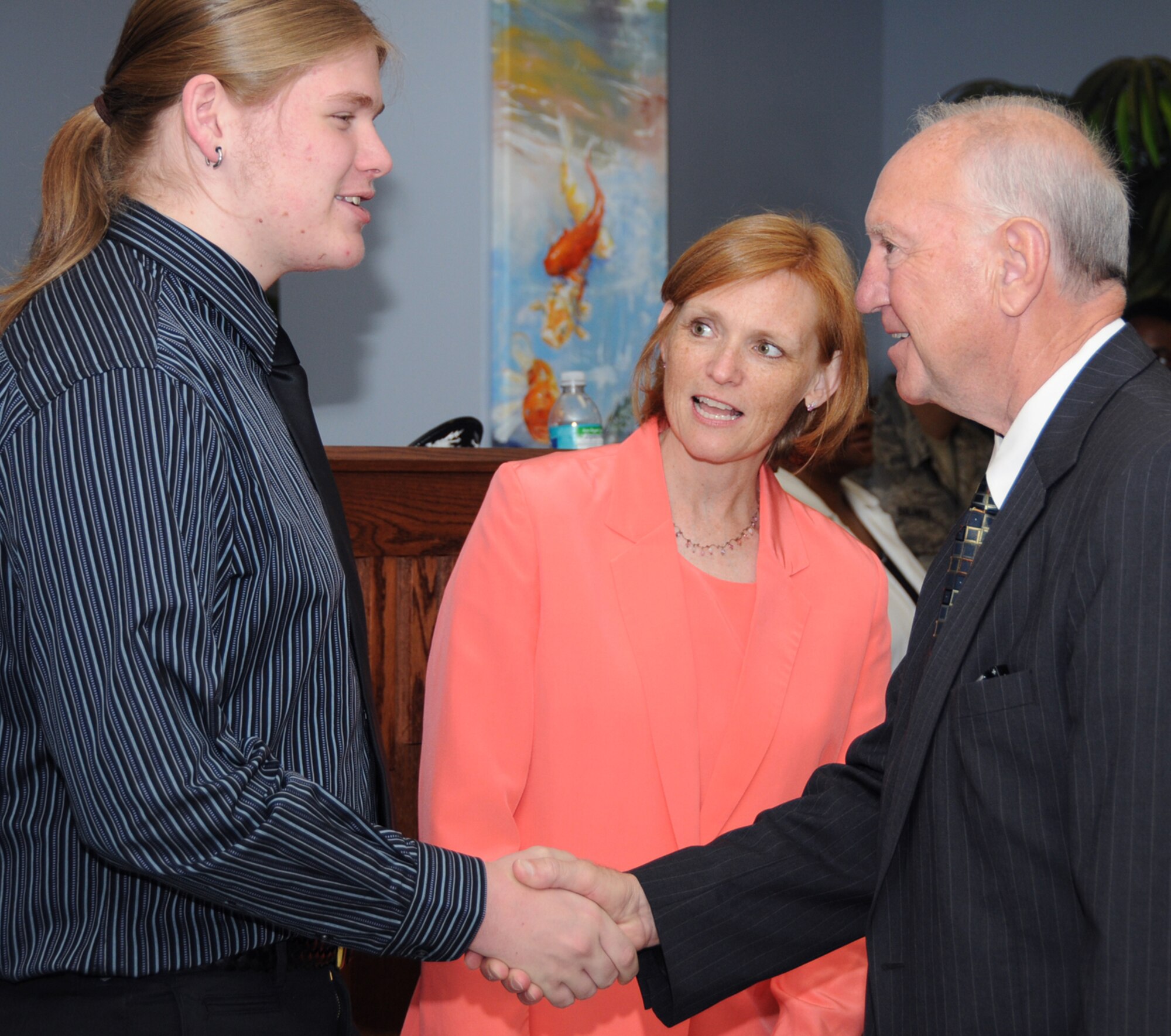 Colonel Dickinson’s son, Nate, and the colonel’s wife, J.J., are welcomed to Keesler by Biloxi Major A.J. Holloway.  (U.S. Air Force photo by Kemberly Groue)