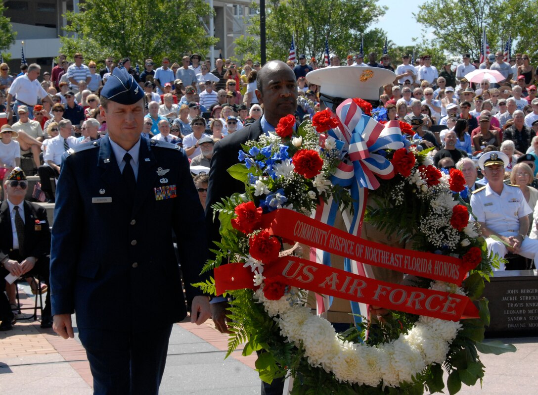 Colonel Robert Branyon, 125th Fighter Wing Commander, steps forward to present a wreath in tribute to the U.S. Air Force at the City of Jacksonville's Memorial Day Tribute to fallen heroes at the Veteran's Memorial Wall in downtown Jacksonville, Fla. May 25, 2009. (Air National Guard Photo by Staff Sgt. Jaclyn Carver)