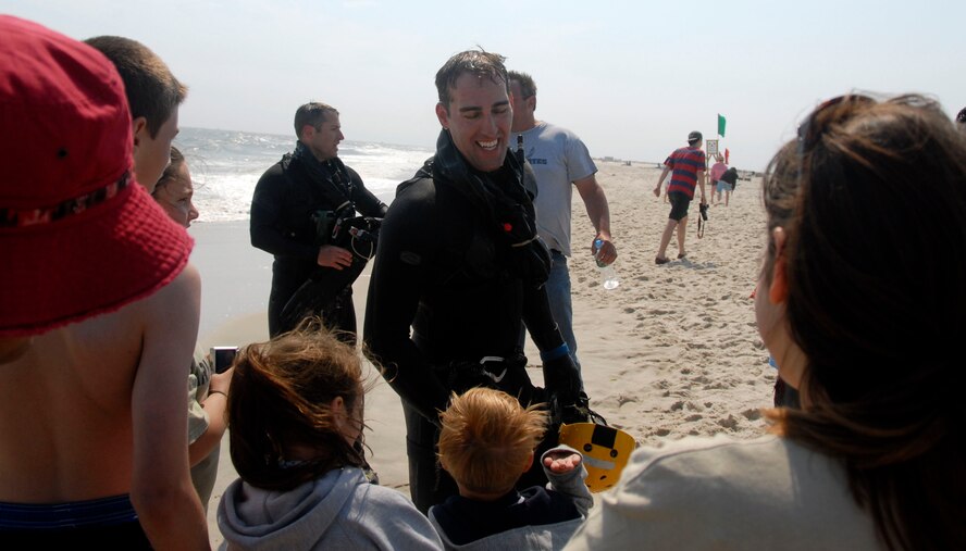 Pararescuemen Staff Sgt. Richard Russillo, and Captain Glyn Weir (left), from the 103rd Rescue Squadron, greet attendees to the Jones Beach Air Show. The 106th Rescue Wing demonstrated a series of different rescue operations during the Jones Beach Air Show at Jones Beach State Park in Wantaugh, N.Y. on May 23 and 24, 2009. The event was narrated by Col. Michael F. Canders, 106th Rescue Wing Commander, and featured members and aircraft from the 101st, 102nd and 103rd Rescue Squadron, such as the HC-130, HH-60, and Pararescue Jumpers. Recruiters and volunteers from the 106th Rescue Wing were also present to answer questions about the aircraft.
(U.S. Air Force Photo/SrA Jose Diaz/Released)
