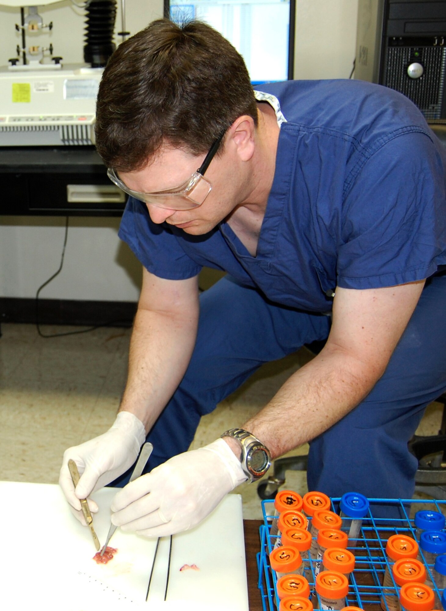Capt. (Dr.) Mark Lytle prepares a tissue sample for testing at the 81st Medical Group’s clinical research laboratory.  Captain Lytle was awarded a $135,000 grant from the Office of the Air Force Surgeon General for his research on staple-line bio-reinforcement for gastrointestinal anastomosis.  The study investigates the use of biomaterials to increase the tensile strength of intestinal tissue to facilitate wound healing while reducing any related side effects of inflammation.  Maj. Eric Olsen, CRL director, said, the study has important military implications in reducing morbidity and mortality associated with intestinal injuries.  Captain Lytle, 81st Surgical Operations Squadron, is a second-year surgery resident currently in fellowship training at the CRL.  (U.S. Air Force photo by Steve Pivnick)