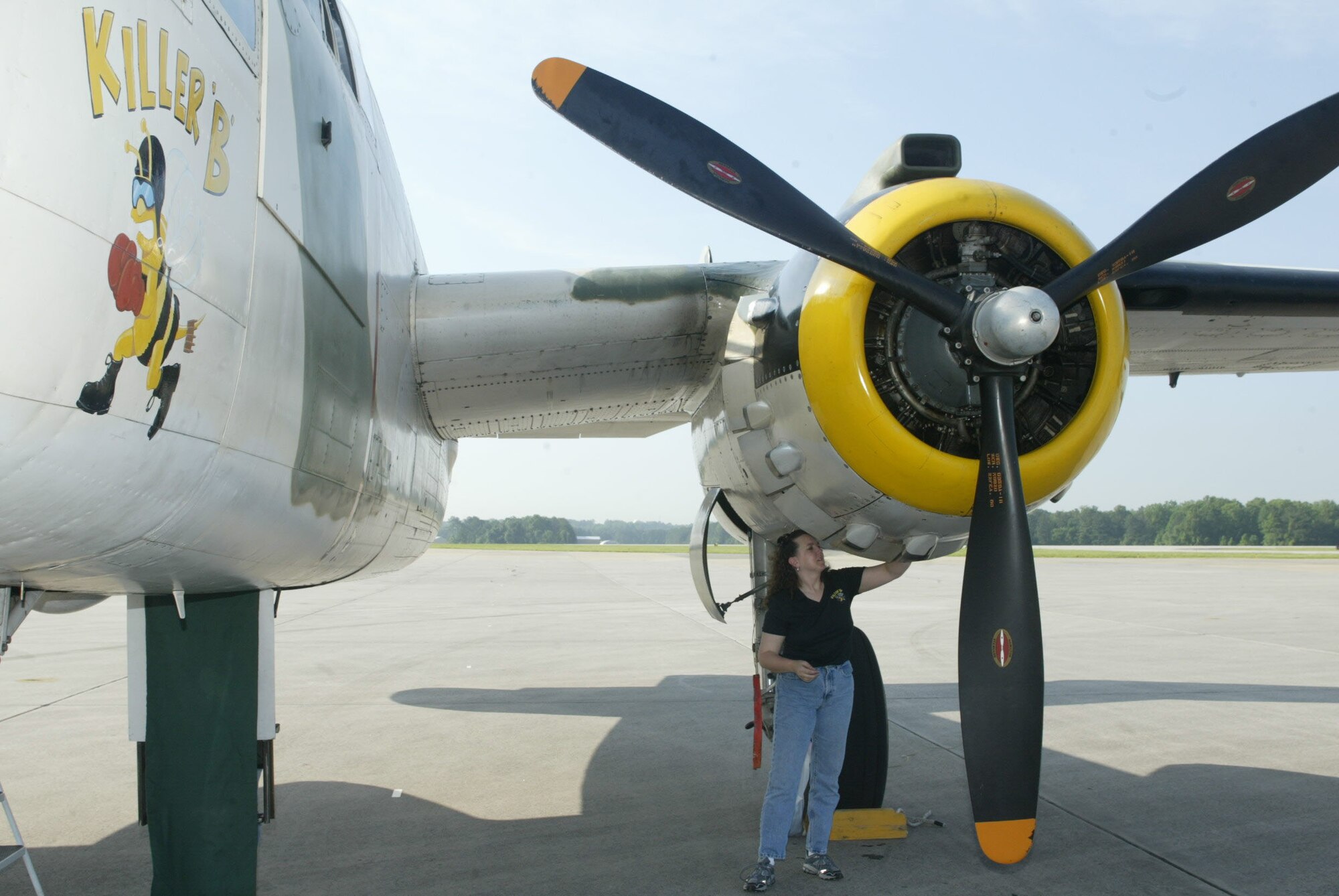DOBBINS AIR RESERVE BASE, Ga. -- Crew member Deeds Lingo wipes down the engine of the "Killer B," a restored B-25 Aircraft, on static display here as a part of the Berlin Airlift 60th Anniversary commemoration May 15.
