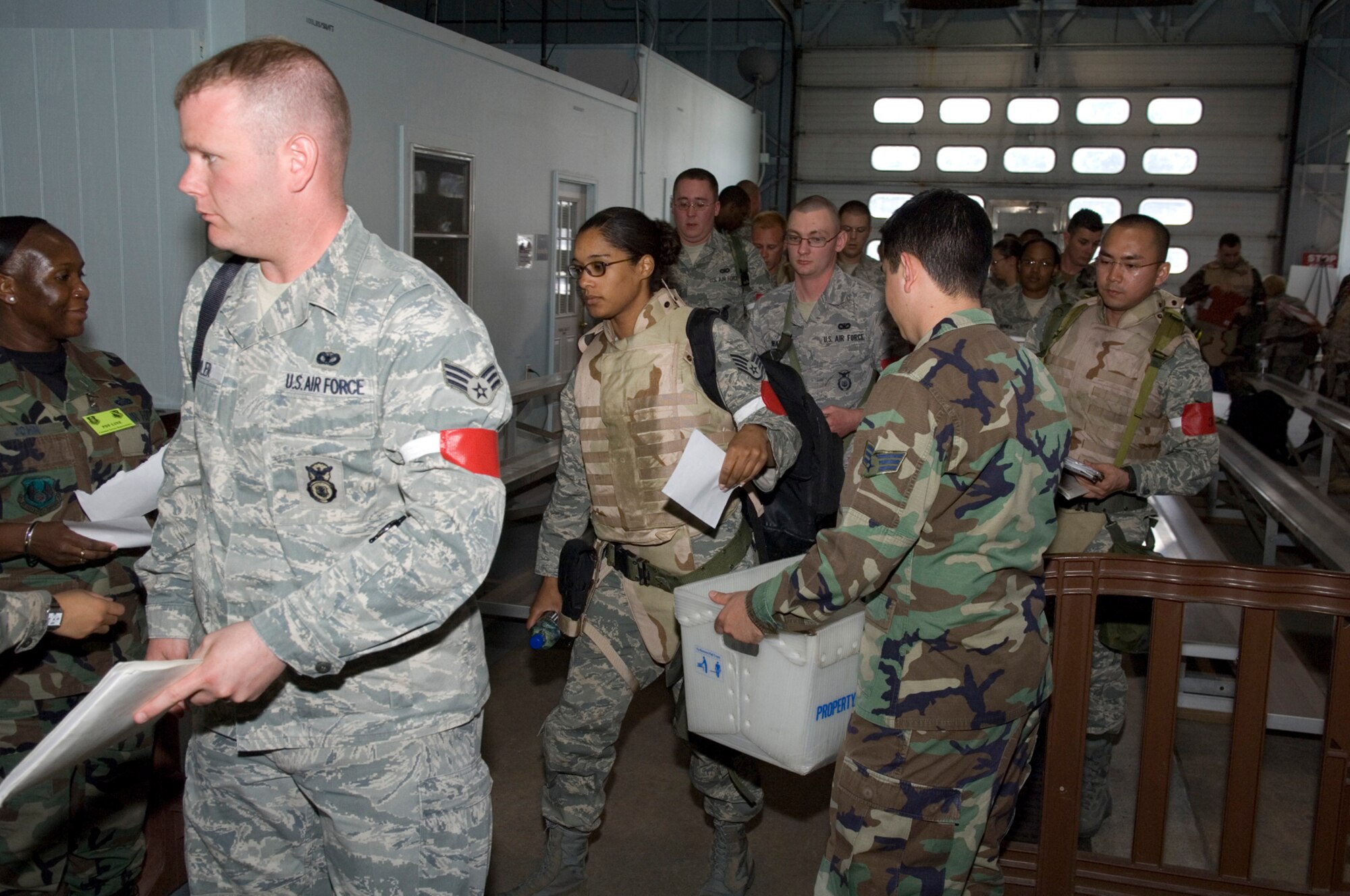 HANSCOM AIR FORCE BASE, Mass. - Airmen process through the deployment line on May 26, during Phase I of the Base Readiness Exercise. The Airmen were being deployed to Camp Patriot as part of a week-long exercise to test Airmen and base personnel on their wartime readiness and deployment processing procedures. The exercise also tested the base’s emergency management procedures. (U.S. Air Force photo by Rick Berry)