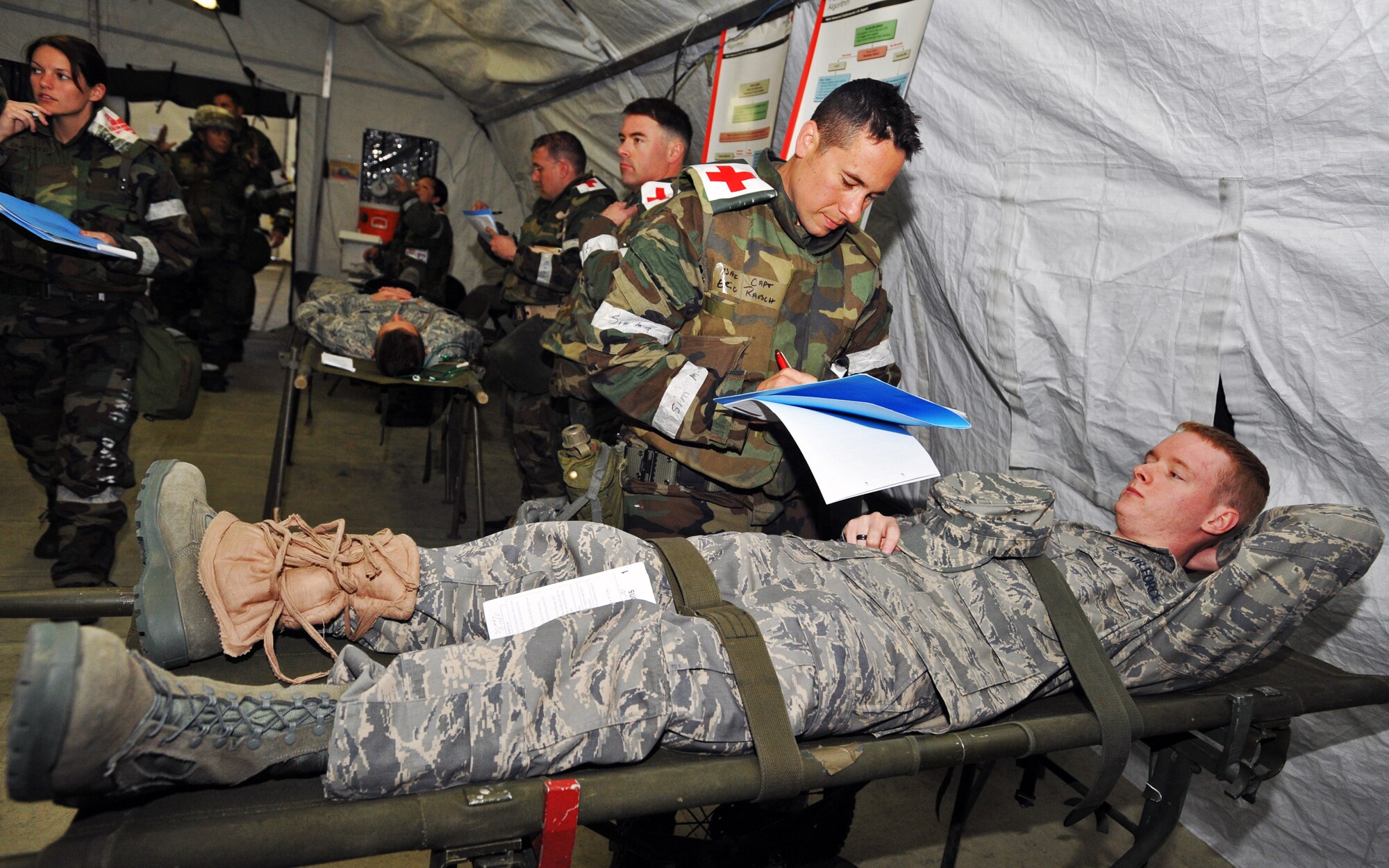 ELMENDORF AIR FORCE BASE, Alaska -- Capt. Eric Rausch, 3rd Medical Group, questions his patient Airman 1st Class Joshua Archer, who suffers from a simulated illness, during Polar Force 09-05 May 20, 2009. The exercise helped to prepare base personnel for the upcoming Operational Readiness Inspection beginning June 1. (U.S. Air Force/Senior Airman Laura Turner)