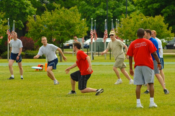 HANSCOM AIR FORCE BASE, Mass. – A player on the 66th Air Base Wing Team (red shirts) attempts a pass to his teammates during the Hanscom Olympics Frisbee football semi-finals match on May 20 between the 66th Air Base Wing and the 350th Electronic Systems Wing. Hanscom’s Olympic games wrapped up on May 21, the 66 ABW was the winner of the Olympic competition, the Air Force Research Laboratory placed second and the 653rd Electronic Systems Wing placed third. For the Commander’s Cup competition AFRL was the top place finisher.  (U.S. Air Force photo by Rick Berry)