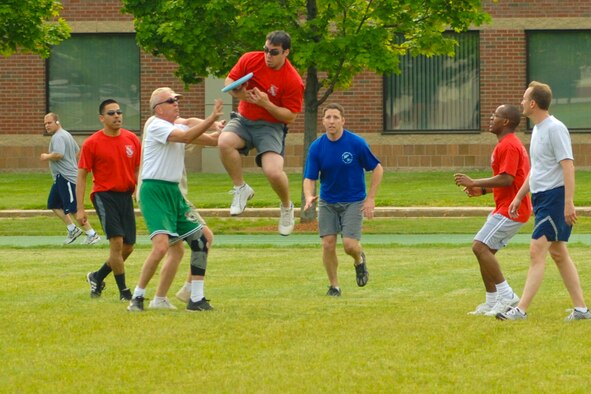 HANSCOM AIR FORCE BASE, Mass. –Mike Clark, 66th Air Base Wing Contracting Squadron, goes airborne to try to catch a Frisbee while Guy Giroux of the 350th Electronic Systems Group tries to intercept the disc during the Hanscom Olympics Frisbee football semi-finals match on May 20 between the 66th Air Base Wing and the 350th Electronic Systems Wing. Hanscom’s Olympic games wrapped up on May 21, the 66 ABW was the winner of the Olympic competition, the Air Force Research Laboratory placed second and the 653rd Electronic Systems Wing placed third. For the Commander’s Cup competition AFRL was the top place finisher. (U.S. Air Force photo by Rick Berry)