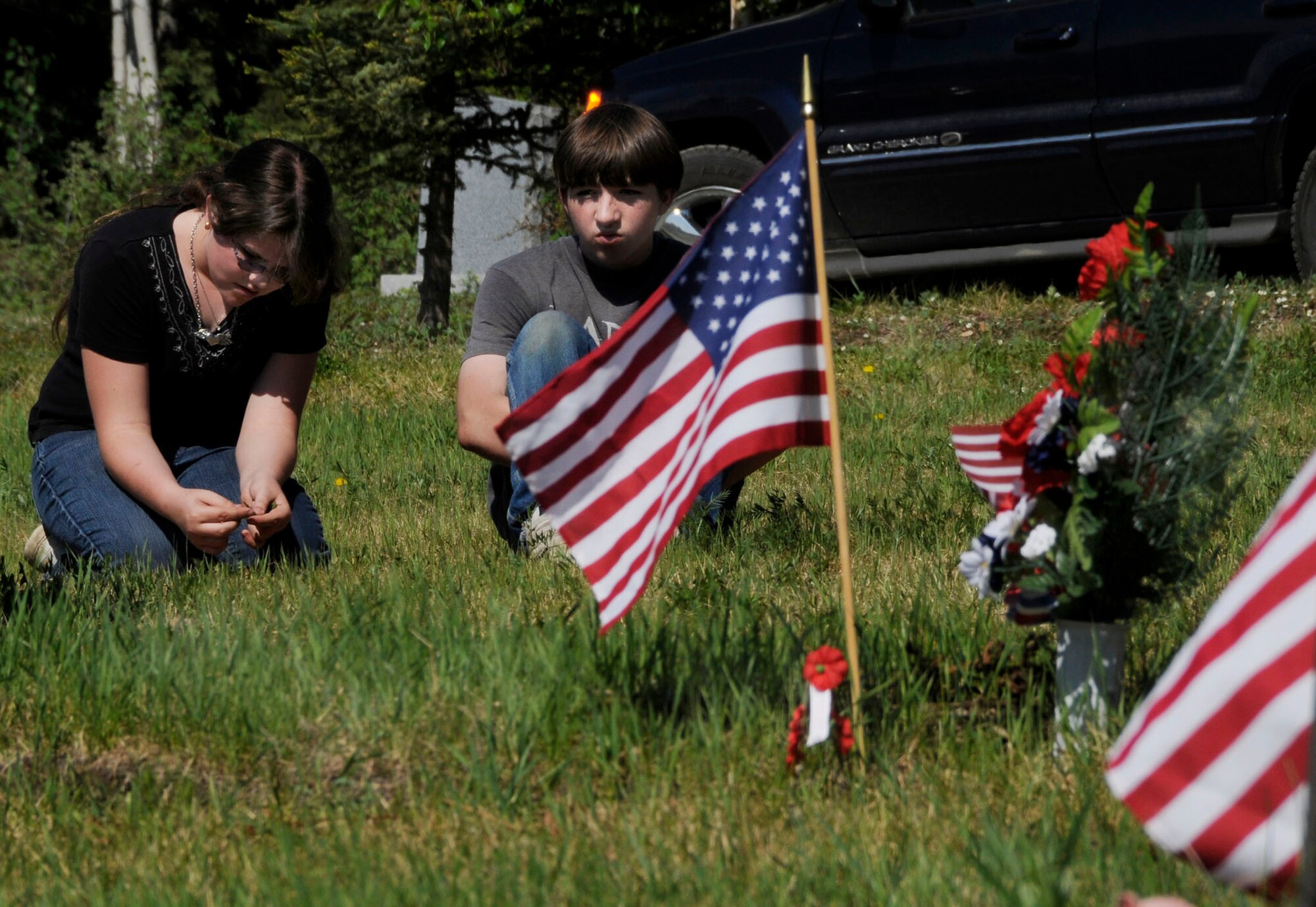 Children observe and learn the importance of Memorial Day at Birch Hill Cemetery May 25, 2009, Fairbanks, Alaska. This day was dedicated to honoring those who had died during the Civil War. Today, these observances honor all Americans who have given their lives in service to our nation. (U.S. Air Force photo/Airman 1st Class Laura Max)