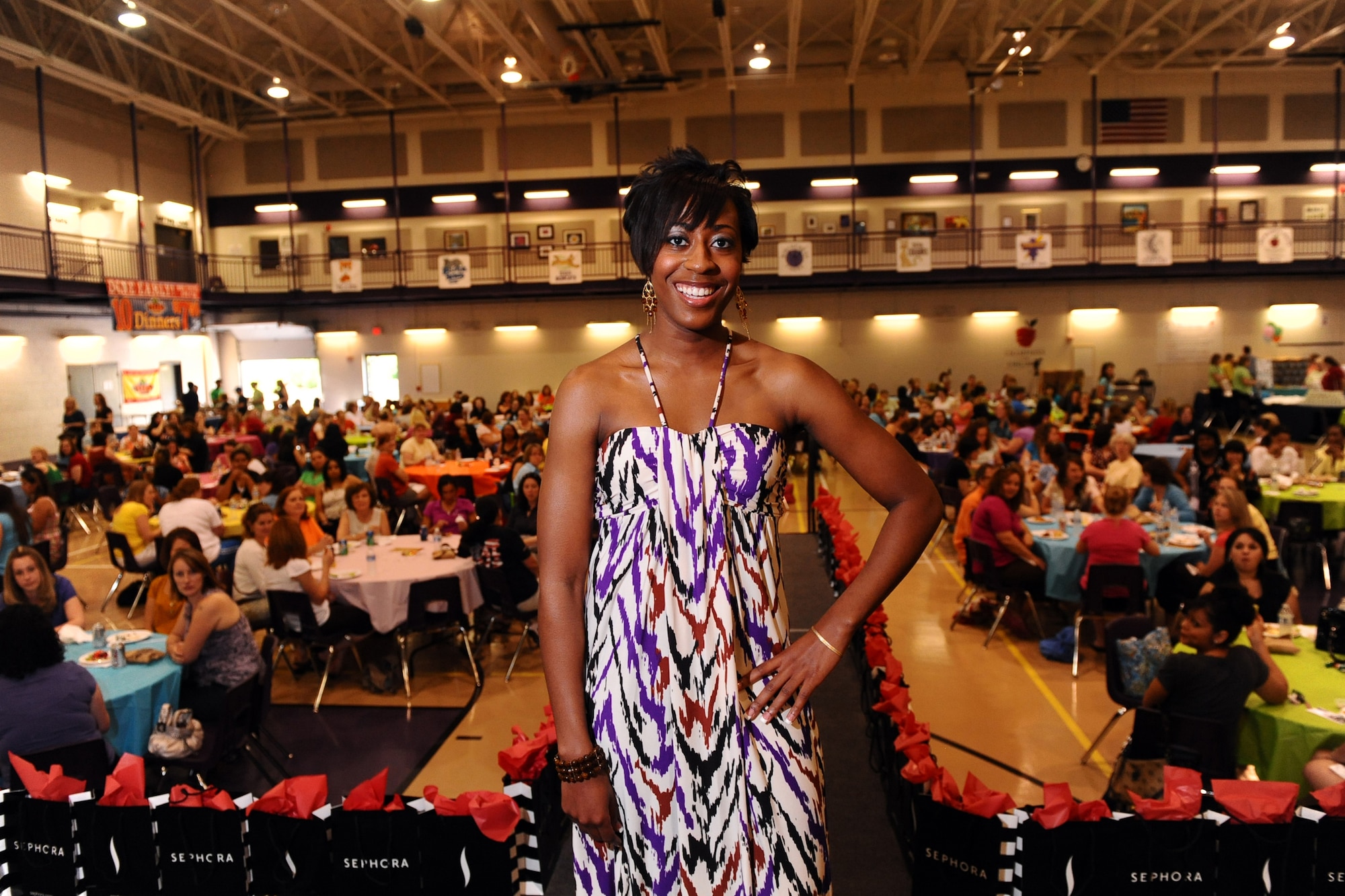 OFFUTT AIR FORCE BASE, Neb. -- Cydney Gaines, a former summer hire with the 55th Wing Public Affairs office, models the seasons latest fashion trends, while hundreds of women enjoy dinner during the 2009 Spring Spa for Spouses at the Bellevue Lied Activity Center May 21. Almost 400 spouses attended the event which consisted of a free dinner, fashion show, massages, manicures and much more. U.S. Air Force Photo by Josh Plueger
