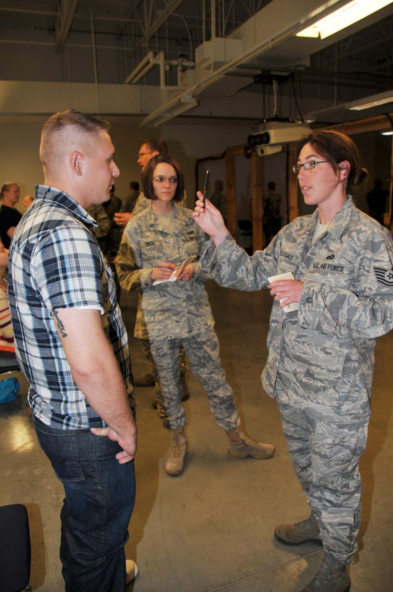 Tech. Sgt. Heather Villegas (right) and Staff Sgt. Grace Bisch (center)administer a field sobriety test to a volunteer during the 934th Security Forces DUI testing training. During the training, volunteers
consumed various amounts of alcohol in a controlled environment and law enforcement personnel from military and civilian agencies were trained in recognizing and testing for intoxication. (Air Force Photo/Master Sgt. Paul Zadach)