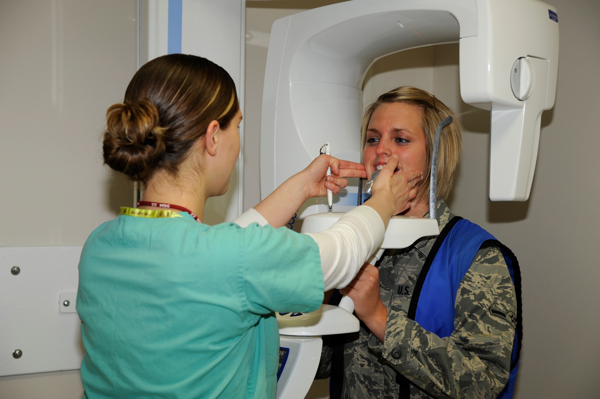 MCCONNELL AIR FORCE BASE, Kan. -- Airman Abby Wiedemann, 22nd Medical Group, has her teeth X-rayed by Sabine Livingston, 22nd Medical Group dental technician, using the dental clinic’s new panoramic X-ray machine, April 28. The panoramic X-ray machine revolves in a 360 degree arc around the patient’s head. (Photo by Airman 1st Class Justin Shelton) 