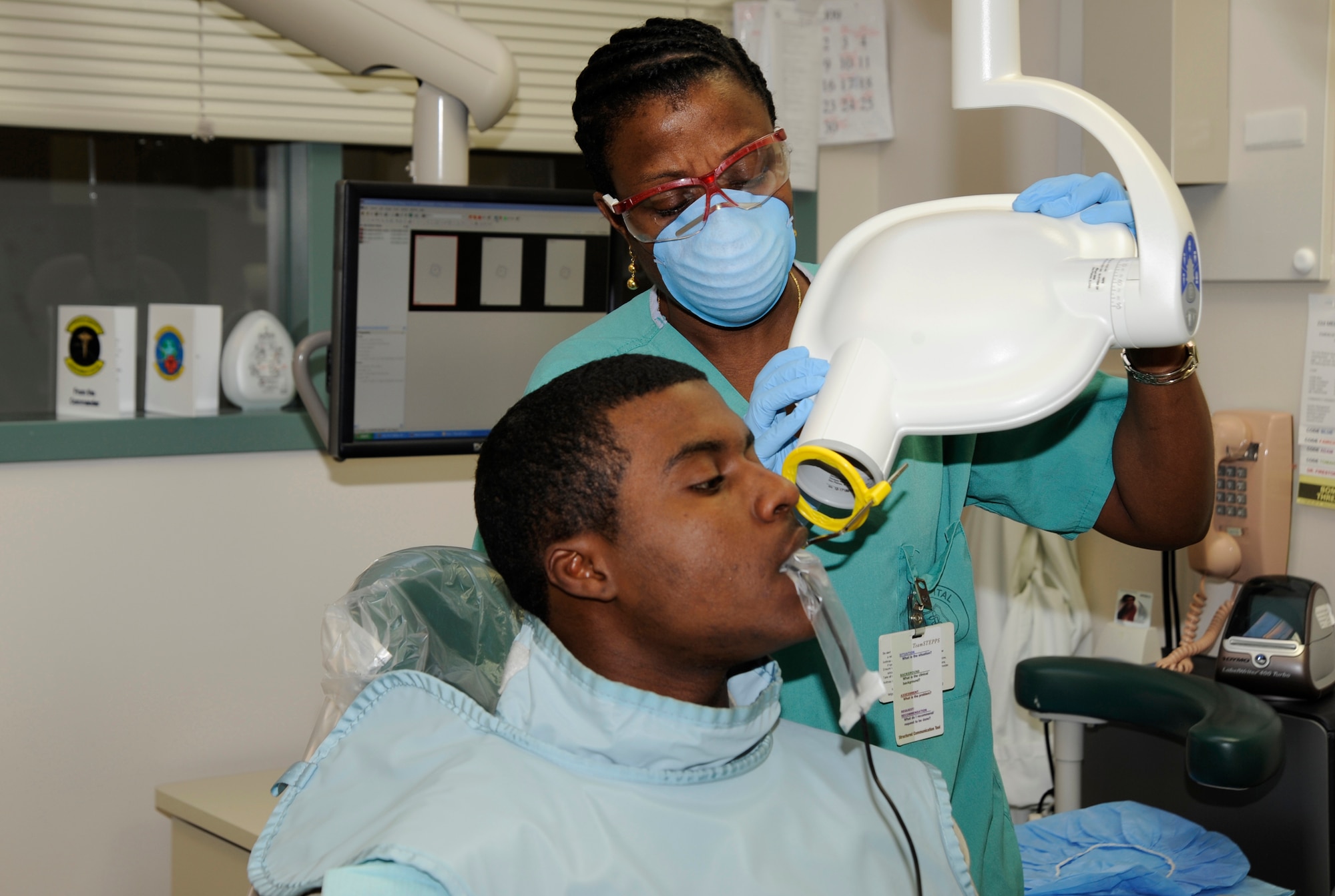 MCCONNELL AIR FORCE BASE, Kan. -- Carmen Jones, 22nd Medical Group dental assistant, X-rays the teeth of Airman Steven Blackman, 22nd Aircraft Maintenance Squadron, with one of the dental clinic’s X-ray machines, during a routine check-up, April 28. The Dental Clinic received two new X-ray machines and has been fully digital since Feb. 11. (Photo by Airman 1st Class Justin Shelton) 