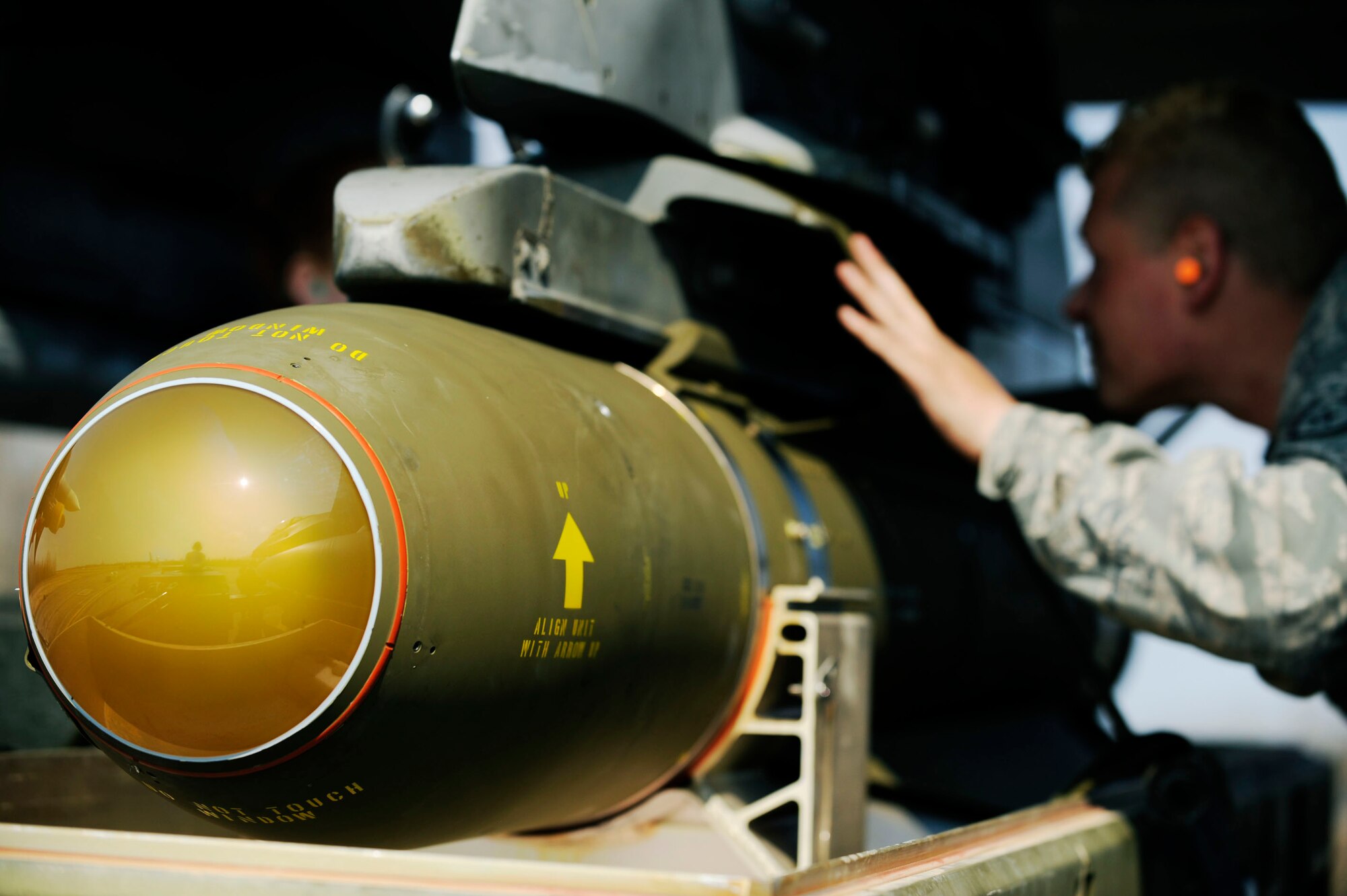 Staff Sgt. Chris Stuckey guides a air-to-ground missle 65 maverick into place on an F-16 Fighting Falcon during Distant Frontier exercise May 08, 2009, Eielson Air Force Base, Alaska. This exercise provides 35th Aircraft Maintenance Unit weapons load crew practice loading a variety of live munitions and pilots will utilize the Joint Pacific Alaskan Range Complex by dropping their entire years supply in a matter of two weeks. Sergeant Stuckey is a weapons load crew member assigned to the 35th Aircraft Maintenance Unit, Kunsan Air Base, Korea.  (U.S. Air Force Photo/Senior Airman Jonathan Snyder)