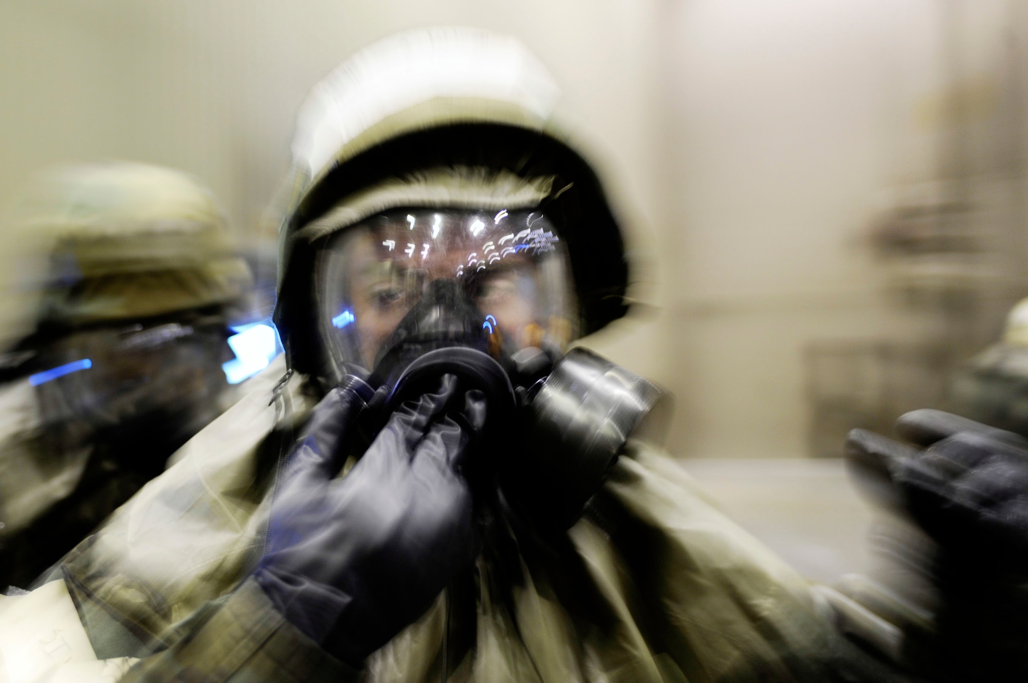 Senior Airman Christopher Wilson is assisted by his wingman while finish donning mission oriented protective posture level four equipment during an ability to survive and operate in a war-time environment evaluation training May 21, 2009, Eielson Air Force Base, Alaska. The operational readiness exercise is designed to test capabilities of deployment readiness and operations in support of war-time tasking. Airman Wilson is assigned to the 354th Operations Support Squadron.  (U.S. Air Force Photo/Senior Airman Jonathan Snyder)