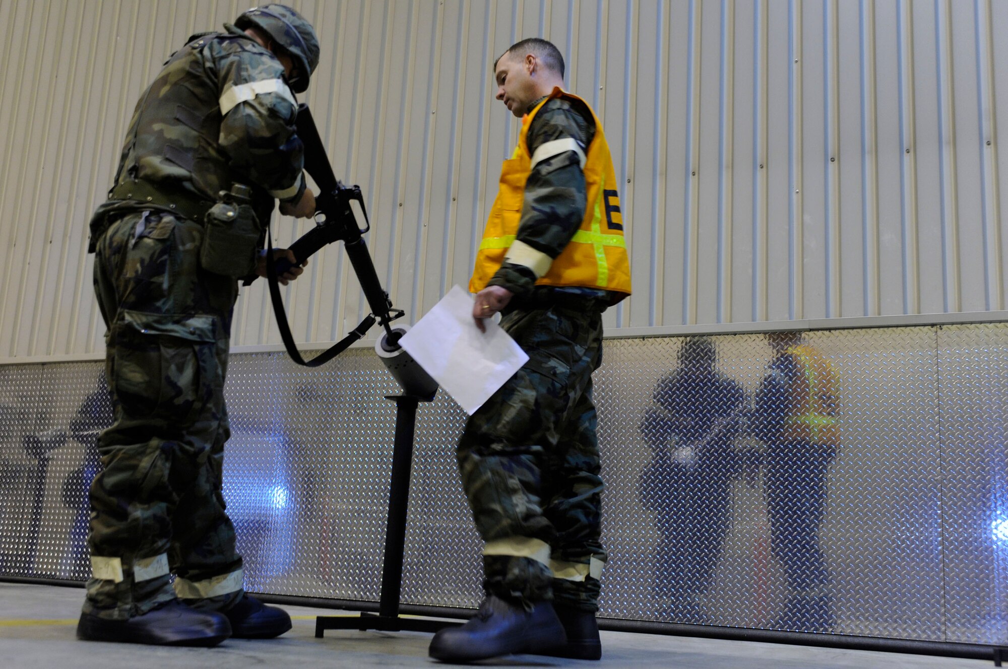 Master Sgt. Scott Austin goes through the clearing process of an M-16 while Tech. Sgt. Chris Culross evaluates how well he performs the task during an ability to survive and operate in a war-time environment evaluation training May 21, 2009, Eielson Air Force Base, Alaska. The ATSO has several stations setup to test Airmen on their ability to perform deployment related operations. Sergeant Culross is assigned to the 354th Security Forces Squadron. Sergeant Austin is assigned to the 354th Civil Engineer Squadron.  (U.S. Air Force Photo/Senior Airman Jonathan Snyder)