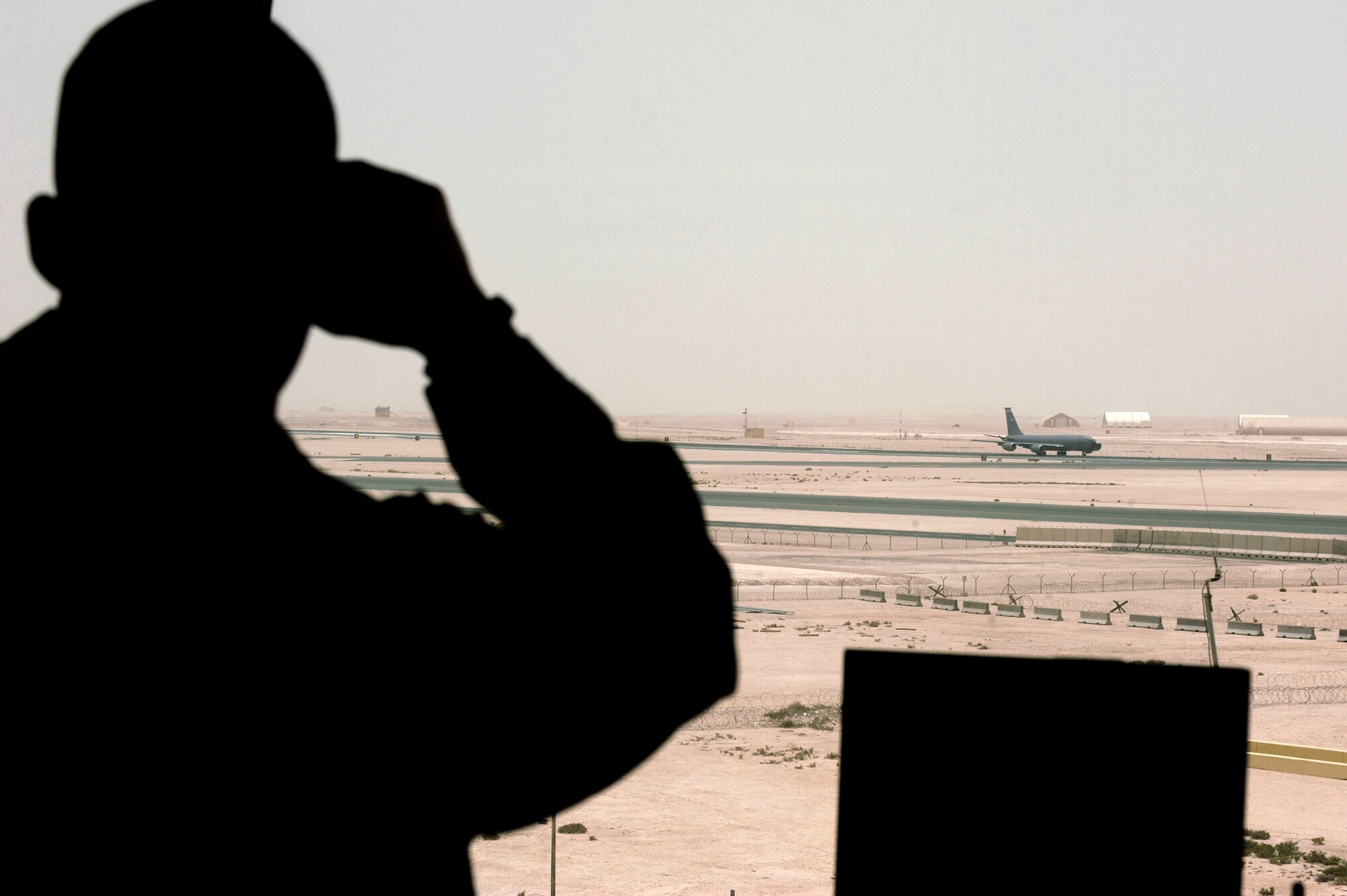 Senior Airman Stephen Boniol monitors a KC-135 Stratotanker as it rolls on its takeoff run May 18 at an air base in Southwest Asia. Airman Boniol and fellow air traffic controllers use binoculars to monitor everything on the flightline from moving aircraft to support equipment and foreign object debris. Airman Boniol is a native of Glenmora, La., and is deployed from Alexandria Air National Guard Base, La. (U.S. Air Force photo/Staff Sgt. Joshua Garcia) 
