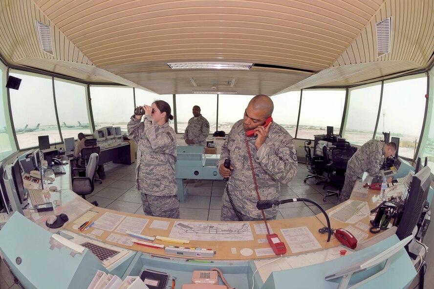 Air traffic controllers from the 379th Expeditionary Operation Support Squadron monitor aircraft movement on the flightline here May 18 at an air base in Southwest Asia. The operation tempo of the flightline can greatly increase at times causing all air traffic controllers to perform multiple tasks at once. (U.S. Air Force photo/Staff Sgt. Joshua Garcia)