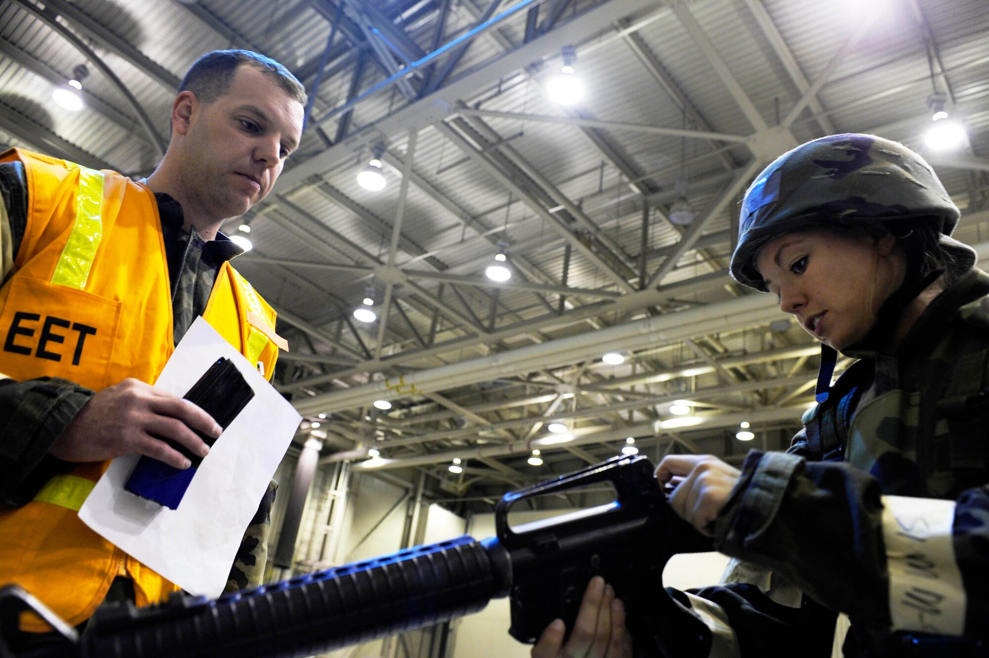 Senior Airman Kasey Dodson goes through the clearing process of an M-16 while Tech. Sgt. Chris Culross evaluates how well she performs the task during an ability to survive and operate in a war-time environment evaluation training May 21, 2009, Eielson Air Force Base, Alaska. The ATSO has several stations setup to test Airmen on their ability to perform deployment related operations. Sergeant Culross is assigned to the 354th Security Forces Squadron. Airman Dodson is assigned to the 354th Civil Engineer Squadron.  (U.S. Air Force Photo/Senior Airman Jonathan Snyder)