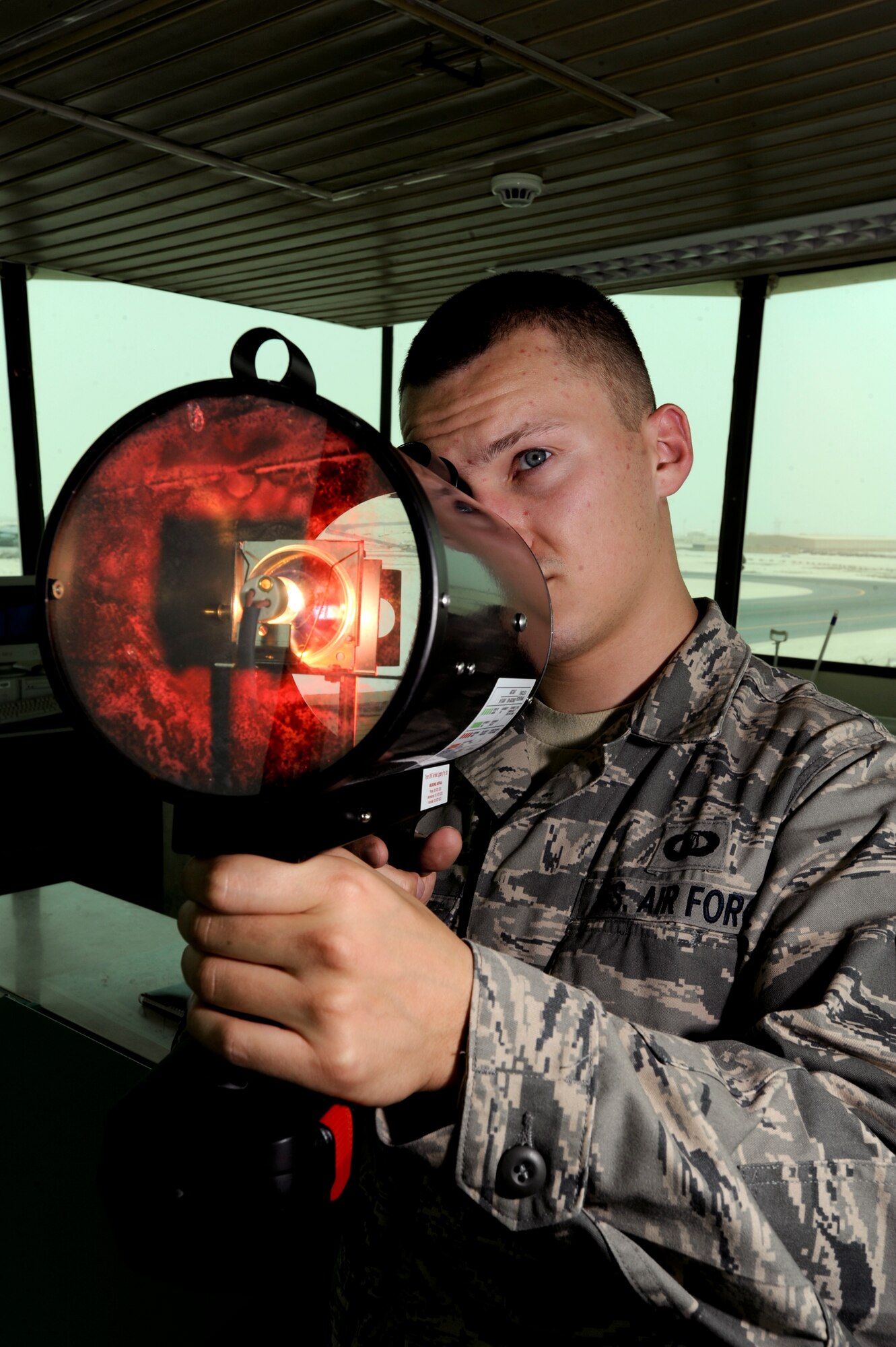 Senior Airman Stephen Boniol uses a control tower light signaling gun May 18 at an air base in Southwest Asia. The light gun is used to communicate with aircraft or ground vehicles during electronic communications failures. Airman Boniol is a 379th Expeditionary Operations Support Squadron air traffic controller deployed from Alexandria Air National Guard Base, La. (U.S. Air Force photo/Staff Sgt. Joshua Garcia) 
