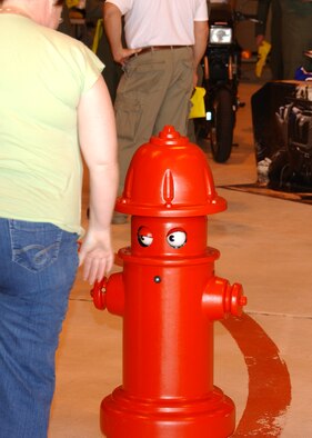 Pluggy, the Vance fire department’s remote controlled fire hydrant, interacts with the people attending the Safety Day Expo. Members of the fire department were on-hand to answer questions. The Safety Day Expo took the place of a traditional safety briefing and was open 9 a.m. to 11 a.m, May 22, in Hangar 170 to kick-off the 101 Critical Days of Summer. (U.S. Air Force Photo/Staff Sgt. Brian Hill)