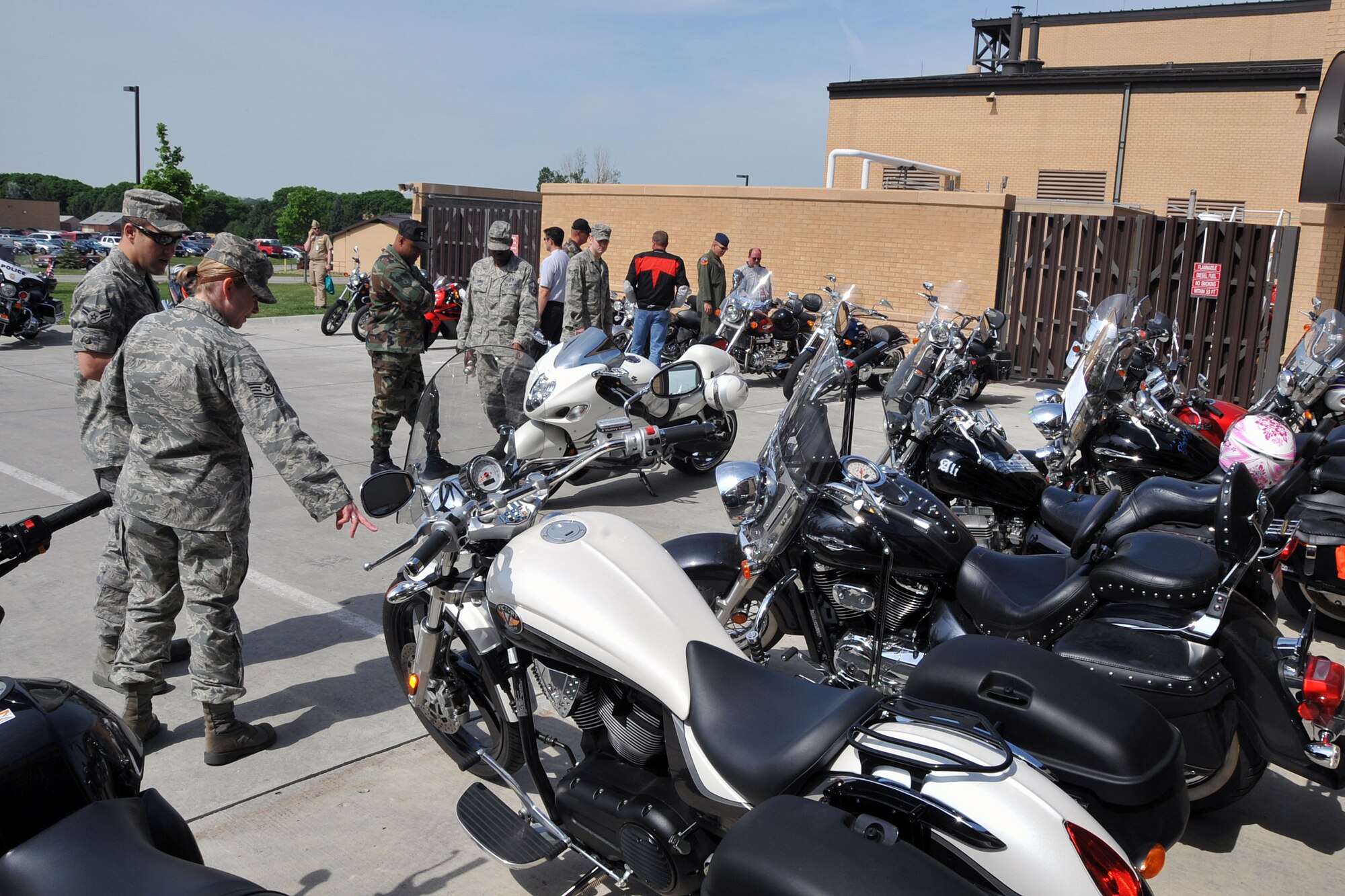 OFFUTT AIR FORCE BASE, Neb. -- Members of Team Offutt gather around premier motorcycles on display during a safety fair at the Offutt Fire House May 21. The safety fair was part of Offutt's annual Safety Day, which focuses on reminding all Airmen to practice safety on a daily basis. U.S. Air Force Photo by Jeff W. Gates