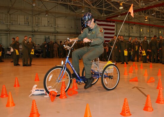 Vance AFB’s Safety Day Expo had a booth that displayed the effects of alcohol on vision and coordination. Lt. Col. Daniel Fischer from the 5th Flying Training Squadron is onboard the tricycle, swerving to avoid hitting more cones in the obstacle course while wearing “beer goggles” used to impair vision, simulating alcohol consumption. The Safety Day Expo took the place of a traditional safety briefing and was open 9 a.m. to 11 a.m, May 22, in Hangar 170 to kick-off the 101 Critical Days of Summer. (U.S. Air Force Photo/Staff Sgt. Brian Hill) 