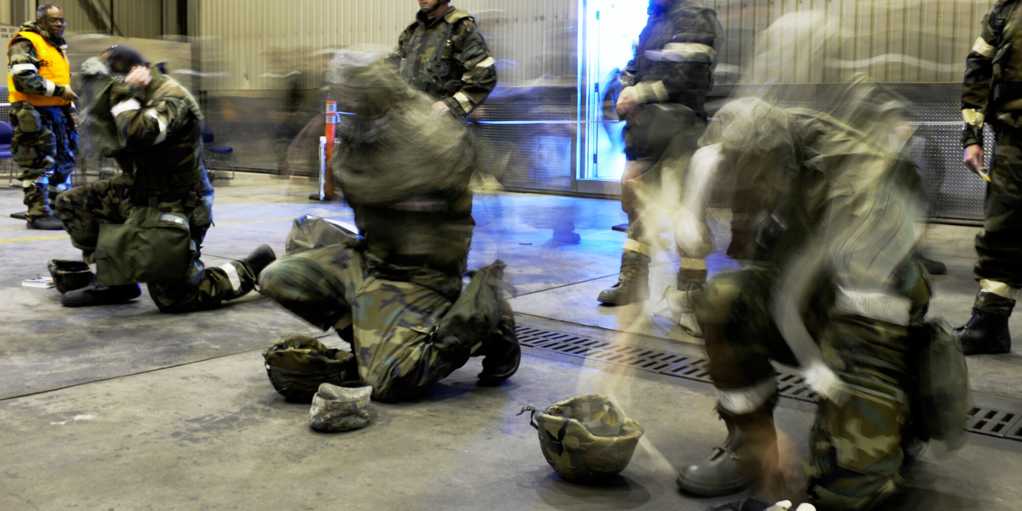 Airman quickly apply mission oriented protective posture level four equipment during an ability to survive and operate in a war-time environment evaluation training May 21, 2009, Eielson Air Force Base, Alaska. The operational readiness exercise is designed to test capabilities of deployment readiness and operations in support of war-time tasking.  (U.S. Air Force Photo/Senior Airman Jonathan Snyder)