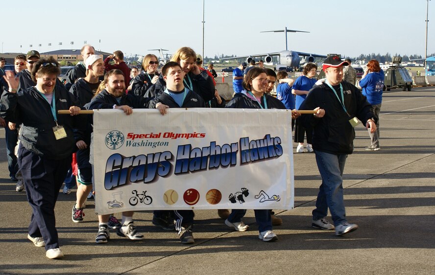 Participants in the 2008 Special Olympics march across the tarmac at McChord Air Force Base, Wash.  The 2009 Special Olympics at McChord and Fort Lewis, Wash., still need more volunteers.  Volunteer opportunties begin May 28 and go through May 31. (U.S. Air Force file photo/Staff Sgt. Eric Burks)