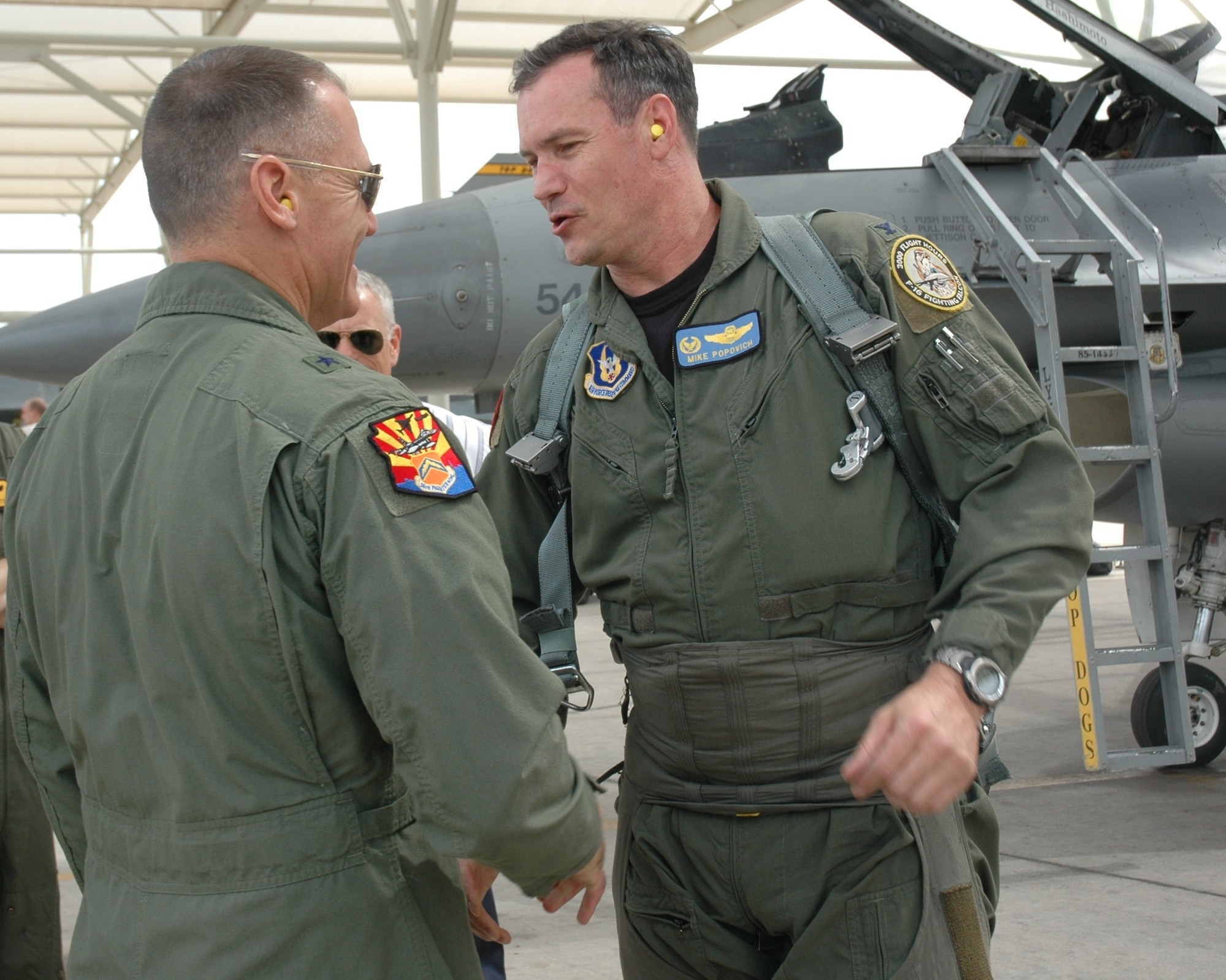 Brig. Gen. Kurt Neubauer, 56th Fighter Wing commander, congratulates Col. Michael Popovich, 944th Fighter Wing commander, on completing his 3,000th flying hour in the F-16 Fighting Falcon May 20. (U.S. Air Force photo/Tech. Sgt. Susan Stout)