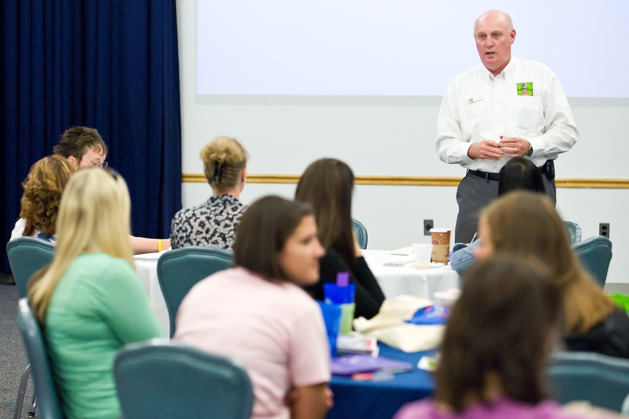 Dan Young, with militaryonesource.com, speaks with spouses during Heart Link at The Landings Club May 20. The Airman and Family Readiness Center hosts Heart Link, an orientation program for Air Force spouses, to help spouses understand the important role they have in the Air Force community. An information fair that included on- and off-base agencies was held after the briefings to inform spouses about different programs and events. (U.S. Air Force photo/Roland Balik)