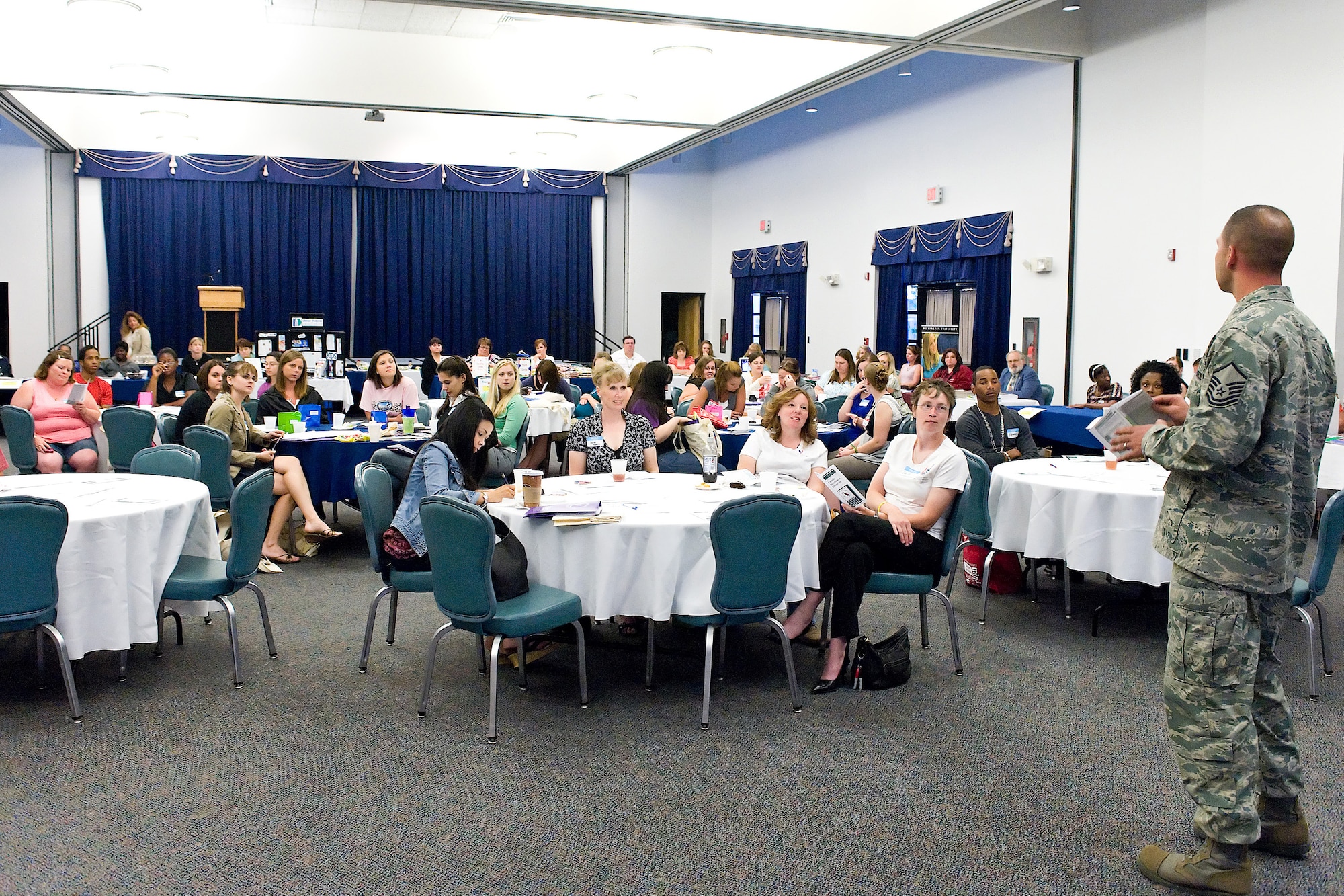 Master Sgt. Shawn Swanson, 436th Force Support Squadron, briefs military spouses during Heart Link, an orientation program for Air Force spouses May 20 at The Landings Club. The Airman and Family Readiness Center hosts Heart Link to provide spouses the chance to learn about different agencies at Dover Air Force Base. (U.S. Air Force photo/Roland Balik)