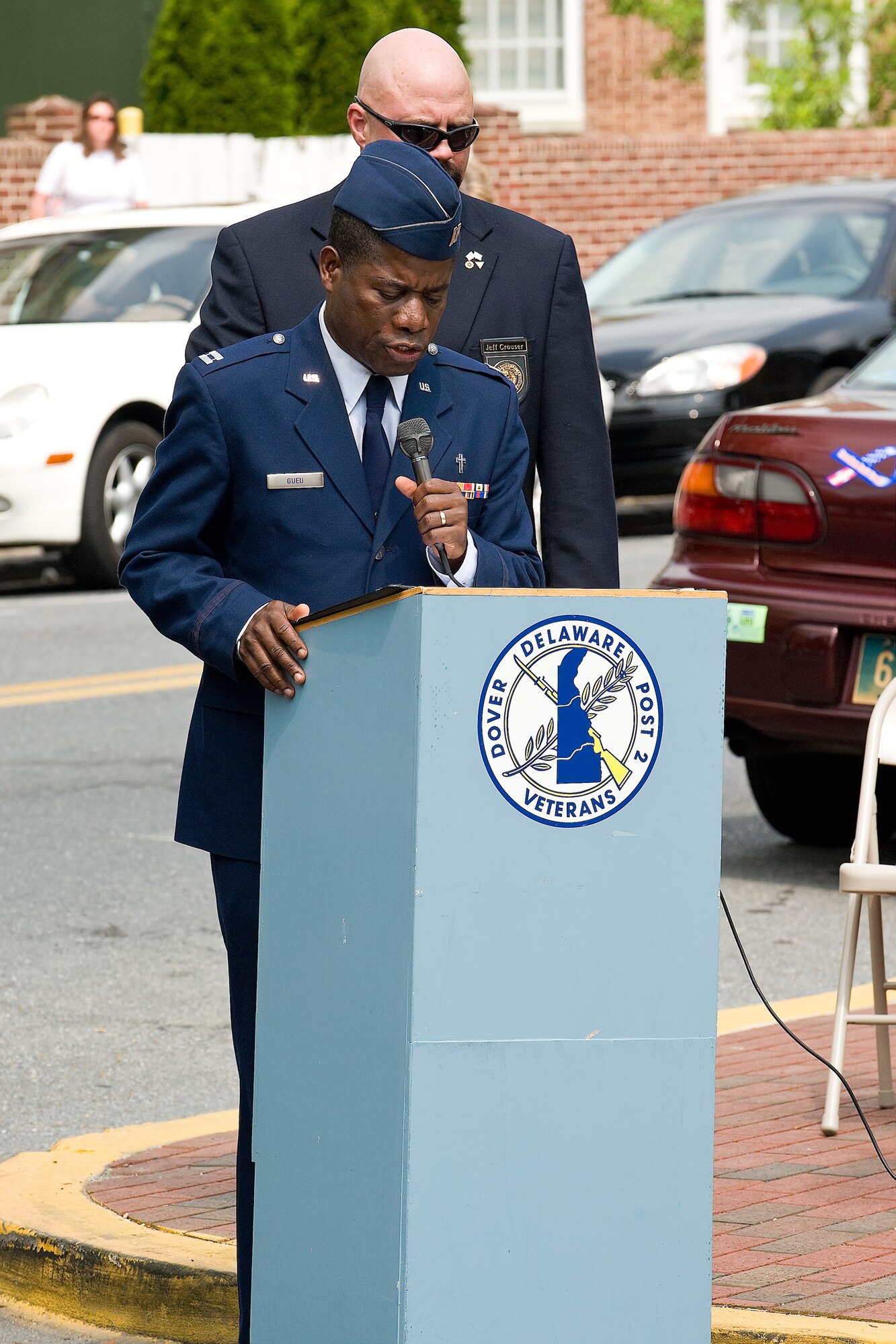 Chaplain (Capt.) Denis Gueu,436th Airlift Wing, offers the opening prayer at a Memorial Day event at the Veterans Triangle in downtown Dover May 25. (U.S. Air Force photo/Roland Balik)