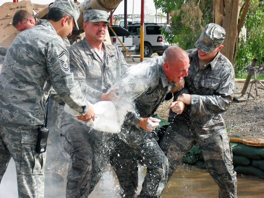 ELMENDORF AIR FORCE BASE, Alaska – Tech. Sgt. Ted Fussell, 506th Expeditionary Civil Engineer Squadron structural craftsman, gets doused with flour and water during a surprise promotion ceremony for him at Kirkuk Regional Air Base, Iraq, May 21. Sergeant Fussell is a firefighter with the Anchorage Fire Department and was recently promoted to Senior Captain. The act of dousing a firefighter with flour and water is a long-standing tradition within the fire department. Sergeant Fussell is a Reservist with Air Force Reserve Command’s 477th Fighter Group at Elmendorf Air Force Base, Alaska. (Courtesy photo)
