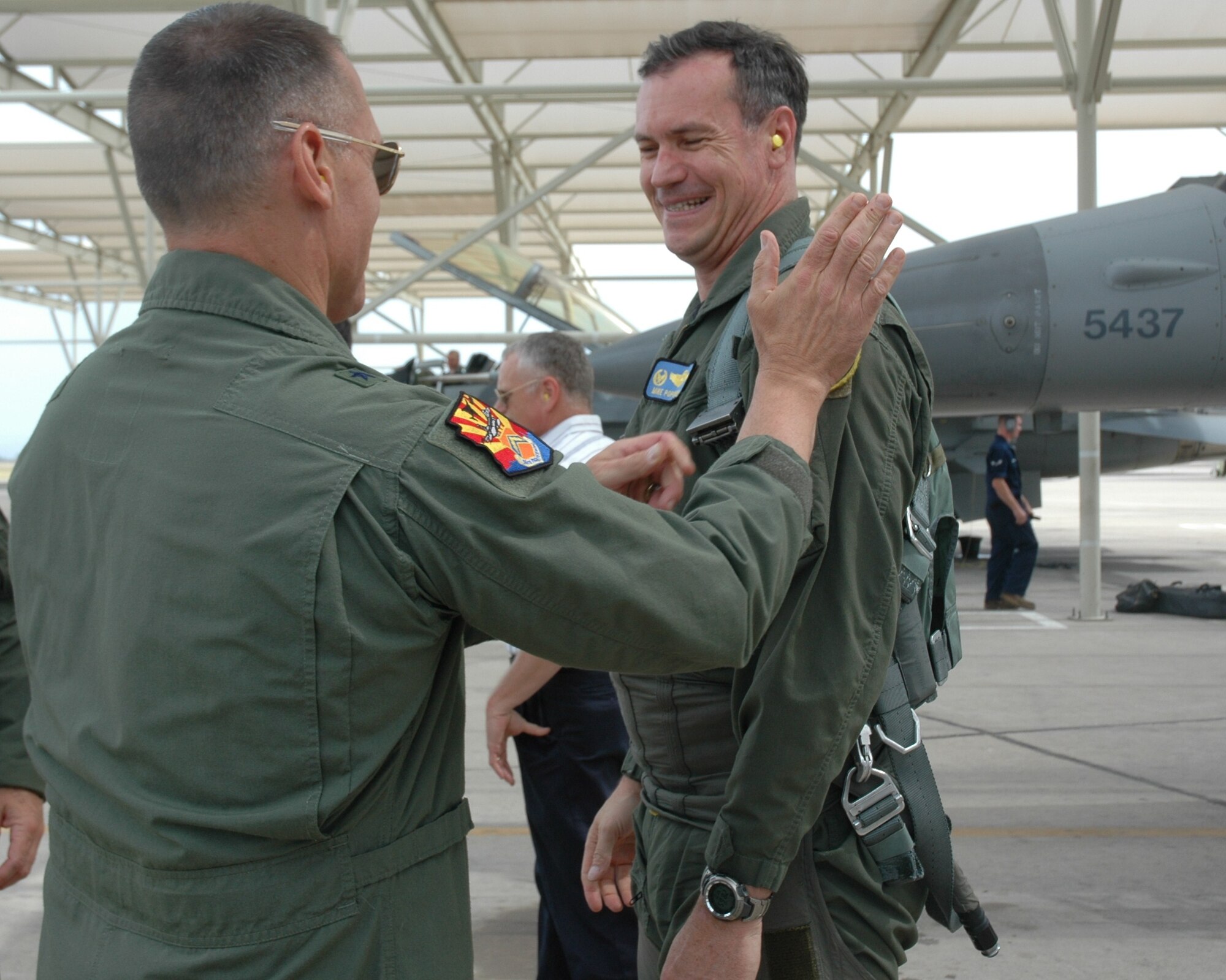 Brig. Gen. Kurt Neubauer, 56th Fighter Wing commander, congratulates Col. Michael Popovich, 944th Fighter Wing commander, on completing his 3,000th flying hour in the F-16 Fighting Falcon May 20. (U.S. Air Force photo/Tech. Sgt. Susan Stout)