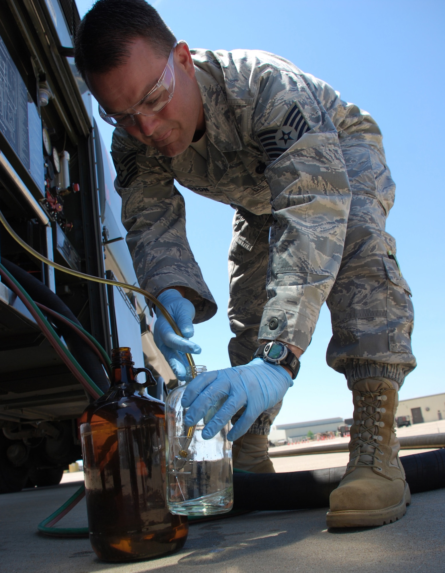 Tech. Sgt. Randy Davidson collects samples of a 50-50 blend of synthetic and JP-8 fuels at the 364th Training Squadron's fuels training yard May 21 at Sheppard Air Force Base, Texas. Sergeant Davidson is part of an Air Force Petroleum Agency team that will conduct tests on the base's Type 3 hydrant system as part of the service's synthetic fuel certification process. The tests should be completed in late October or early November. (U.S. Air Force photo/John Ingle) 
