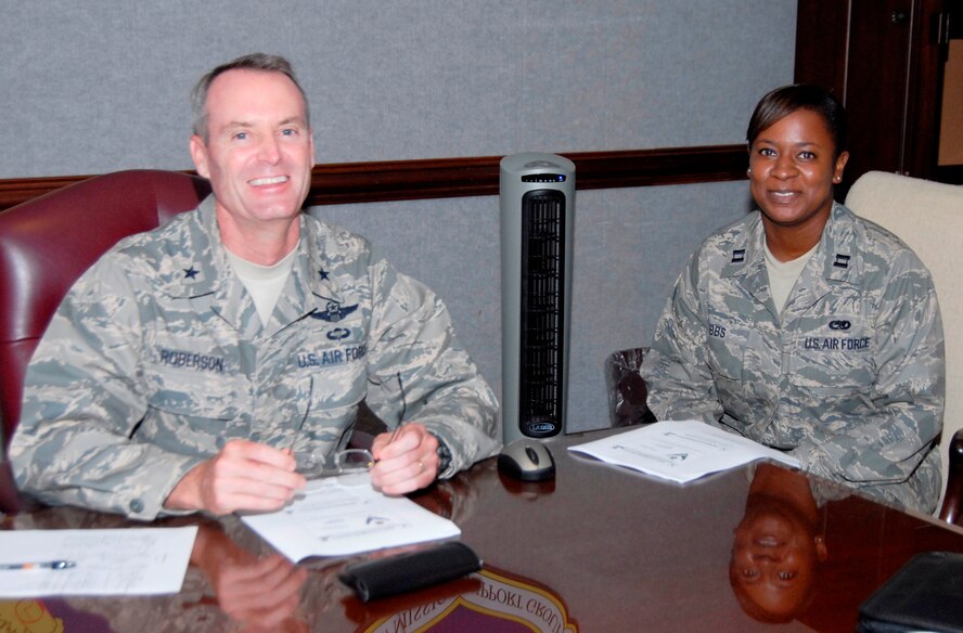 Capt. Tygina Bibbs, 325th Aircraft Maintenance Squadron, 2nd Air Maintenance Unit officer-in-charge, shadows Brig. Gen. Darryl Roberson, 325th Fighter Wing commander, during the commander’s staff meeting May 26.  Captain Bibbs leads a unit comprised of 245 aircraft maintenance Airman and overseas and schedules maintenance operations to sustain 26 aircrafts.  Captain Bibbs spent the day with General Roberson as part of the Commander’s Shadow Program.  She has five years in the military and is a native of Stockbridge, Ga. (U.S. Air Force photo/Robin Walters)  