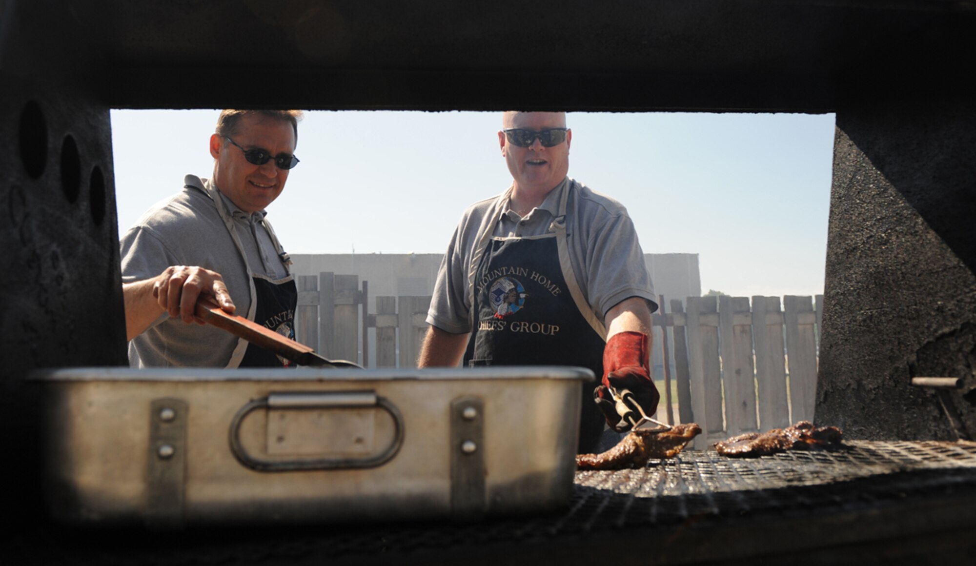 MOUNTAIN HOME AIR FORCE BASE, Idaho -- Chief Master Sgt. Michael Barrie (left), 366th Equipment Maintenance Squadron, and Chief Master Sgt. Kevin Firestone, 366th Component Maintenance Squadron, grill steaks at the Chiefs Steak Burn May 20. The money raised from the steak burn gets distributed to various organizations for their awards throughout Mountain Home Air Force Base. The next steak burn is scheduled June 17 at the Community Center from 11 a.m. to 1 p.m. (U.S. Air Force photo/ Airman 1st Class Renishia Richardson)